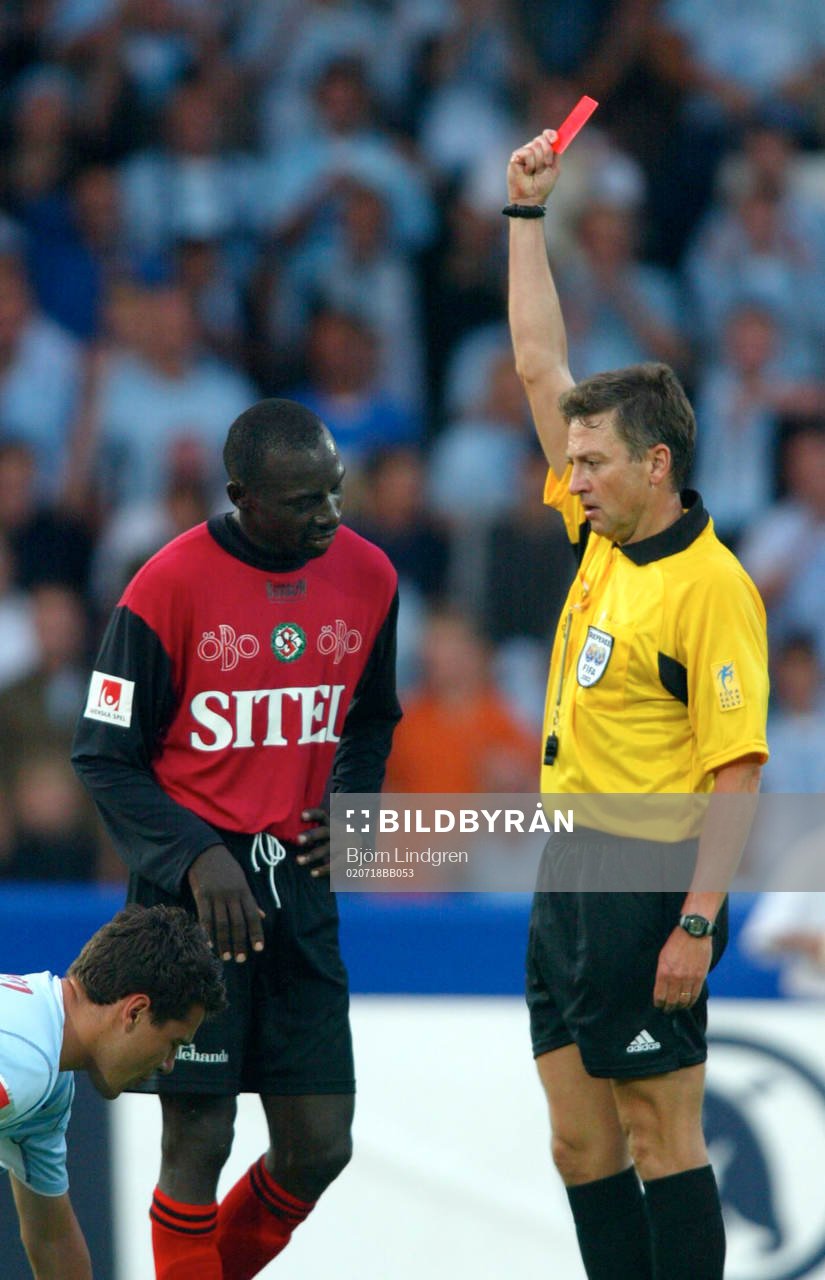  Paul Oyuga visas ut efter en armbåge i magen på Gudmundur Mete. Domare, rött kort.