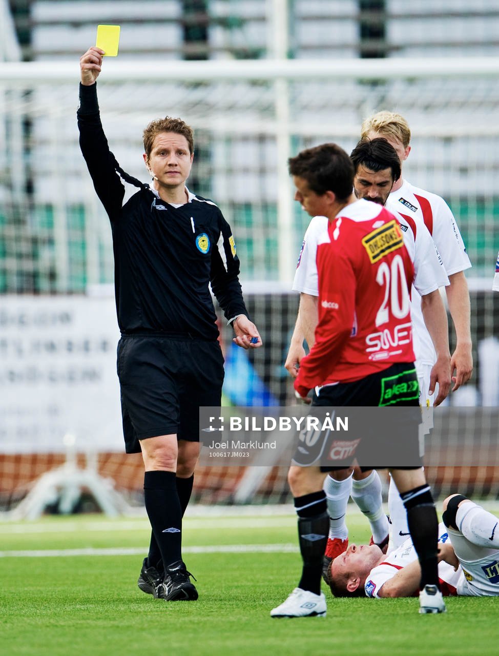 Martin Strömbergsson, domare, delar ut ett gult kort
