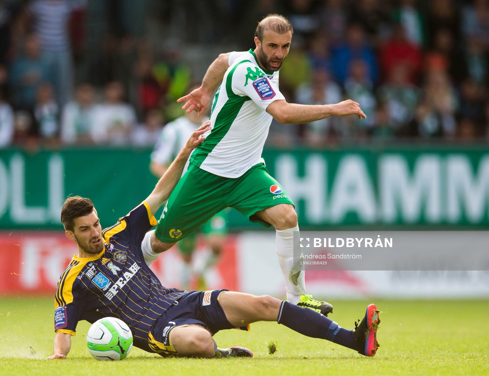 Hammarbys Kennedy Bakircioglü i kamp om bollen med Ängelholms Muamet Asanovski i matchen mellan Hammarby och Ängelholm i Superettan i fotboll 23 Juni 2013 i Stockholm.