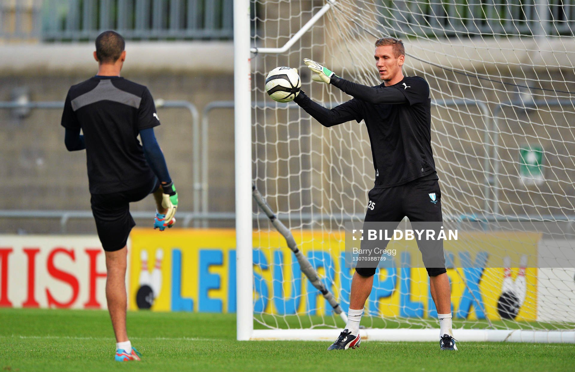 Malmö goalkeepers Robin Olsen, right, practices with