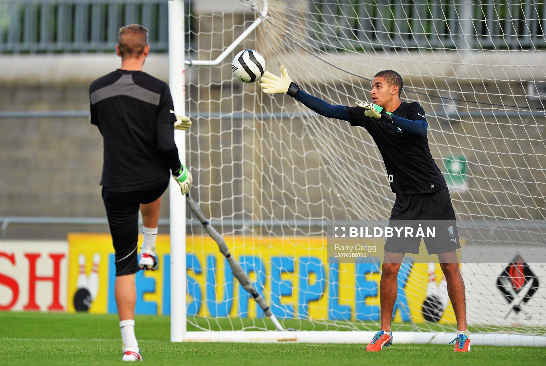 Malmö goalkeepers Robin Olsen, left practices with Sixten