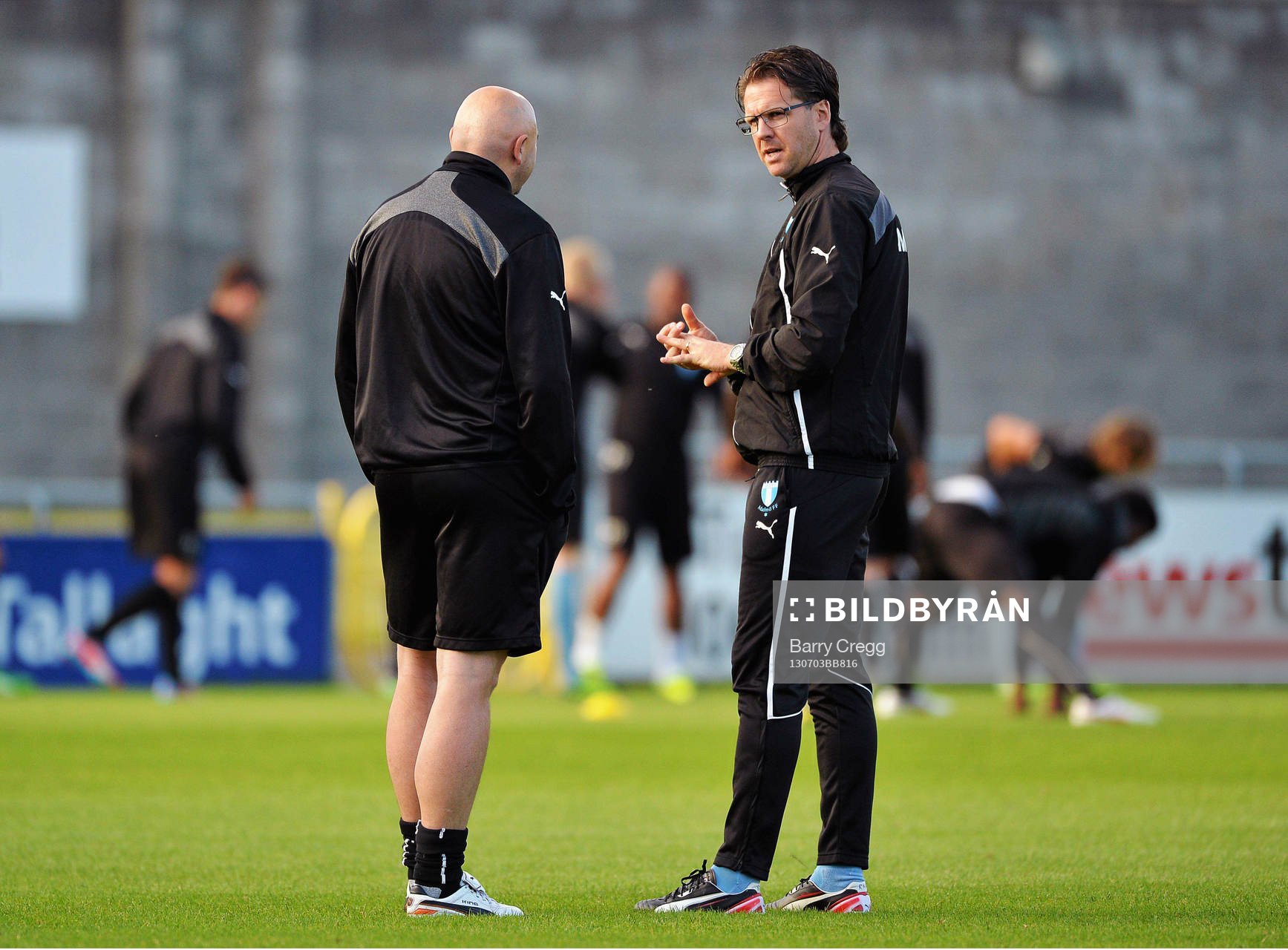 Malmö manager Rikard Norling, right, speaking to chief