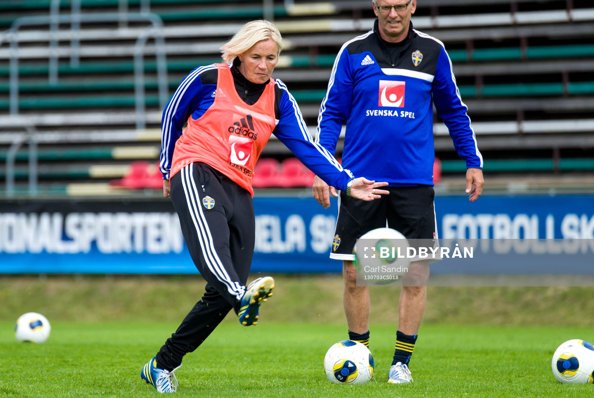 Sveriges assisterande förbundskapten Lilie Gutke Persson skjuter mot mål under träningen inför matchen mot England den 3 juli 2013 i Ljungskile. I bakgrunden assisterande förbundskapten Birger Jacobsson.
