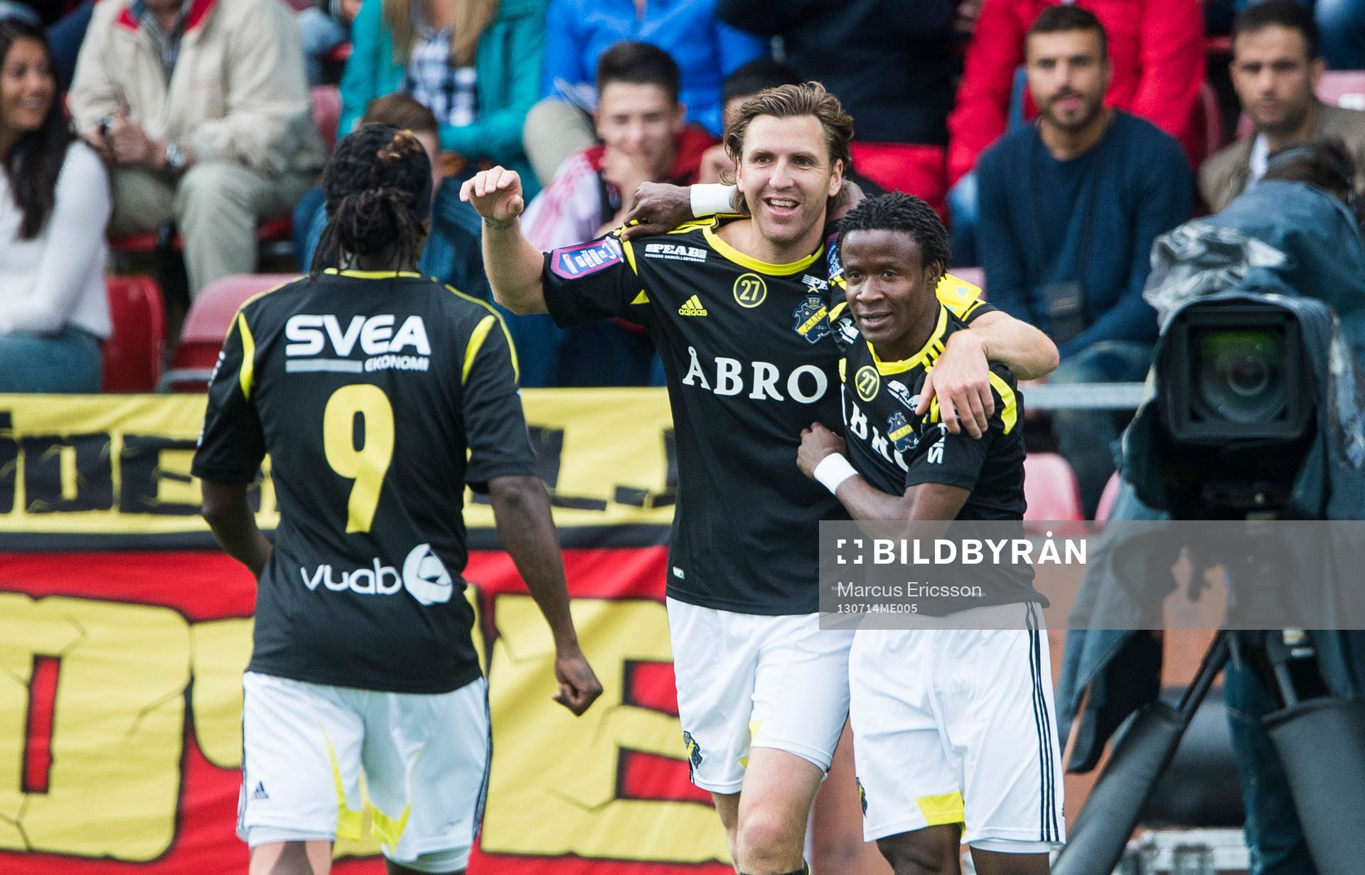 AIK:s Kennedy Igboananike firar sitt 1-0 mål tillsammans med Martin Kayongo-Mutumba och Nils-Eric Johansson i den allsvenska matchen mellan Syrianska och AIK den 14 juli 2013 i Södertälje.