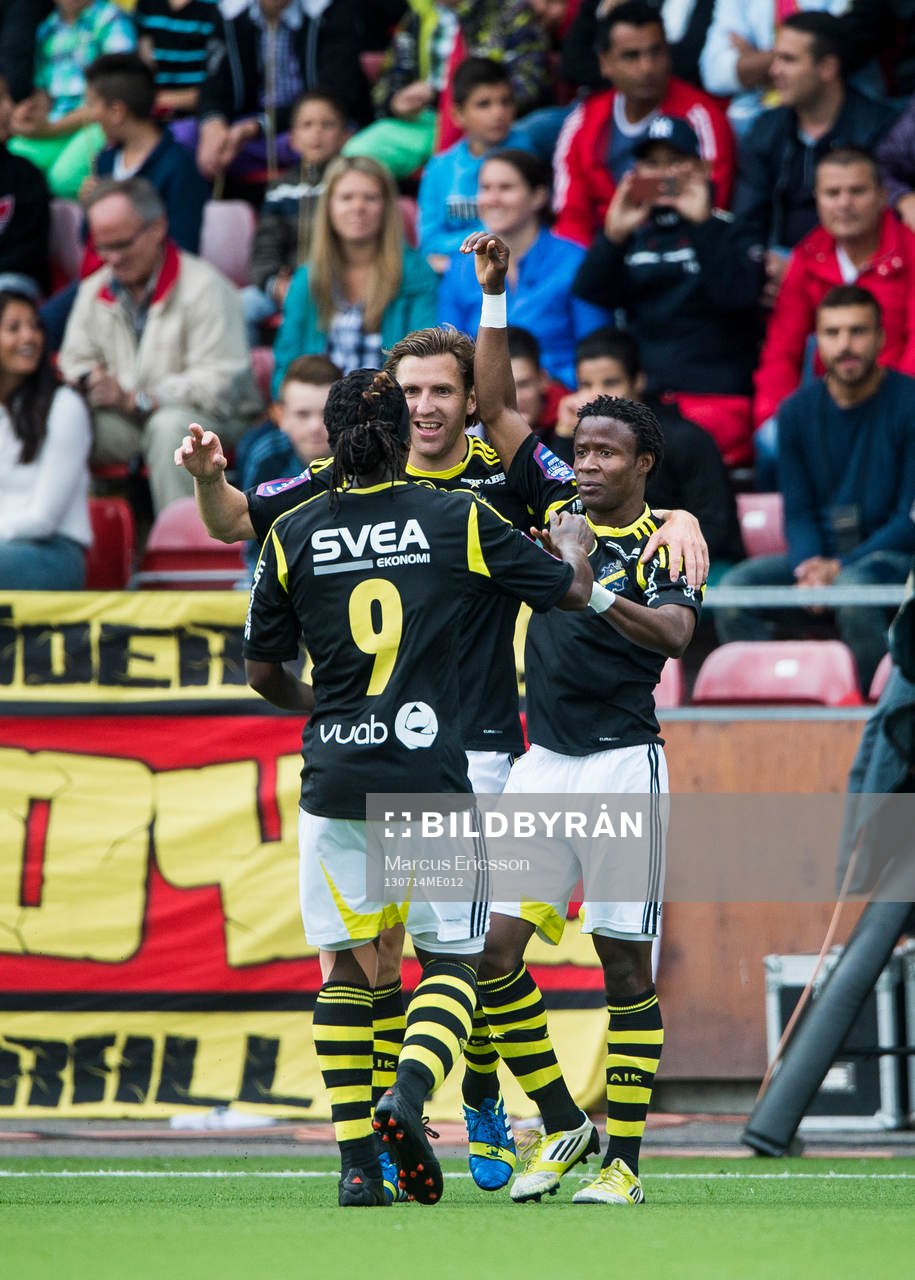 AIK:s Kennedy Igboananike firar sitt 1-0 mål tillsammans med Martin Kayongo-Mutumba och Nils-Eric Johansson i den allsvenska matchen mellan Syrianska och AIK den 14 juli 2013 i Södertälje.
