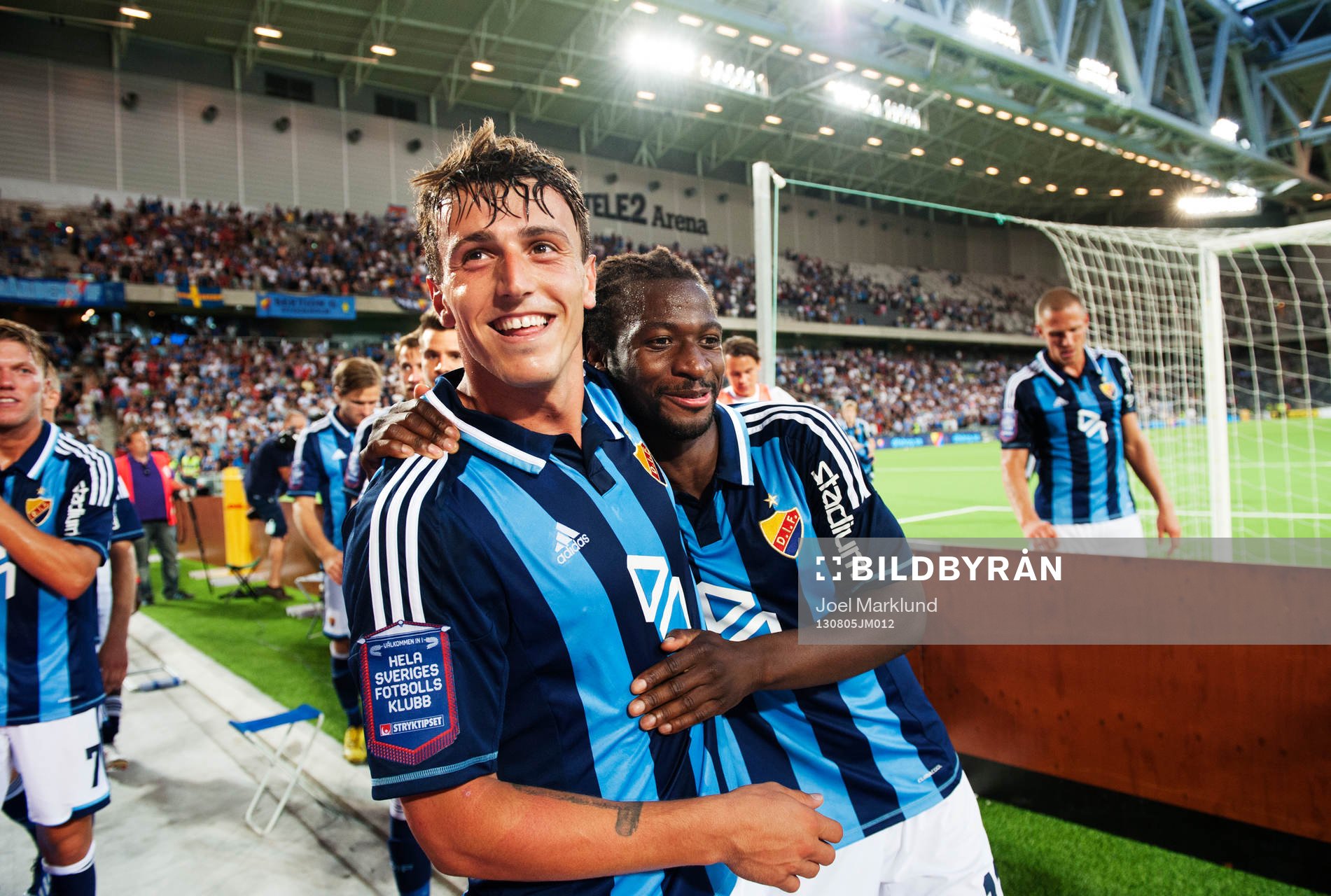 Djurgårdens Erton Fejzullahu och Amadou Jawo kramar om varandra framför fansen efter fotbollsmatchen i Allsvenskan mellan Djurgården och Helsingborg den 5 augusti 2013 i Stockholm.