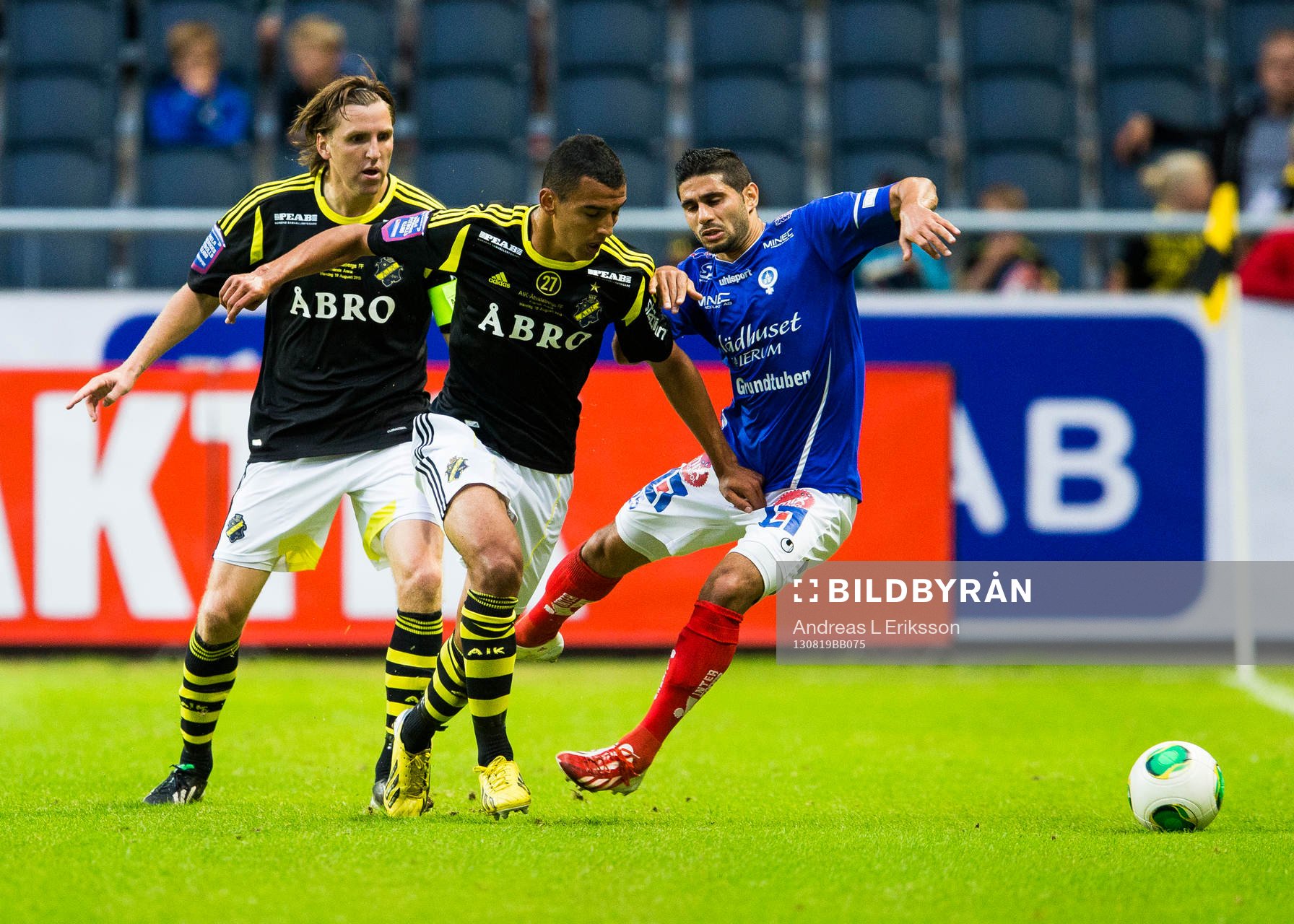 AIKs Nils-Eric Johansson och Nabil Bahoui i kamp om bollen med Åtvidabergs Imad Zatara under fotbollsmatchen i Allsvenskan mellan AIK och Åtvidaberg den 19 augusti 2013 i Stockholm.