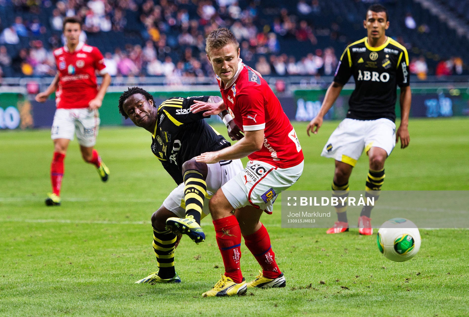 AIK:s Kennedy Igboananike stoppas av Kalmars Mats Solheim under fotbollsmatchen i Allsvenskan mellan AIK och Kalmar den 15 september 2013 i Stockholm.