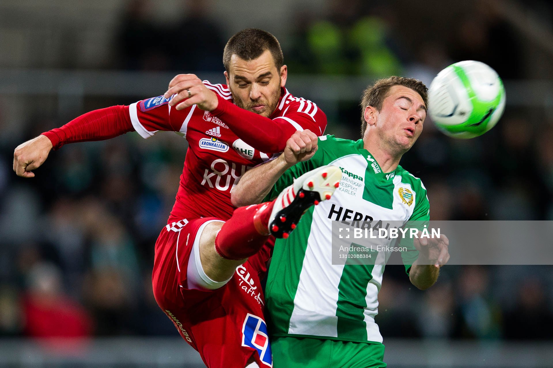 Degerfors Andreas Holmberg rensar bort bollen framför Hammarbys Nikolas Ledgerwood under fotbollsmatchen i Superettan mellan Hammarby och Degerfors den 20 oktober 2013 i Stockholm. 