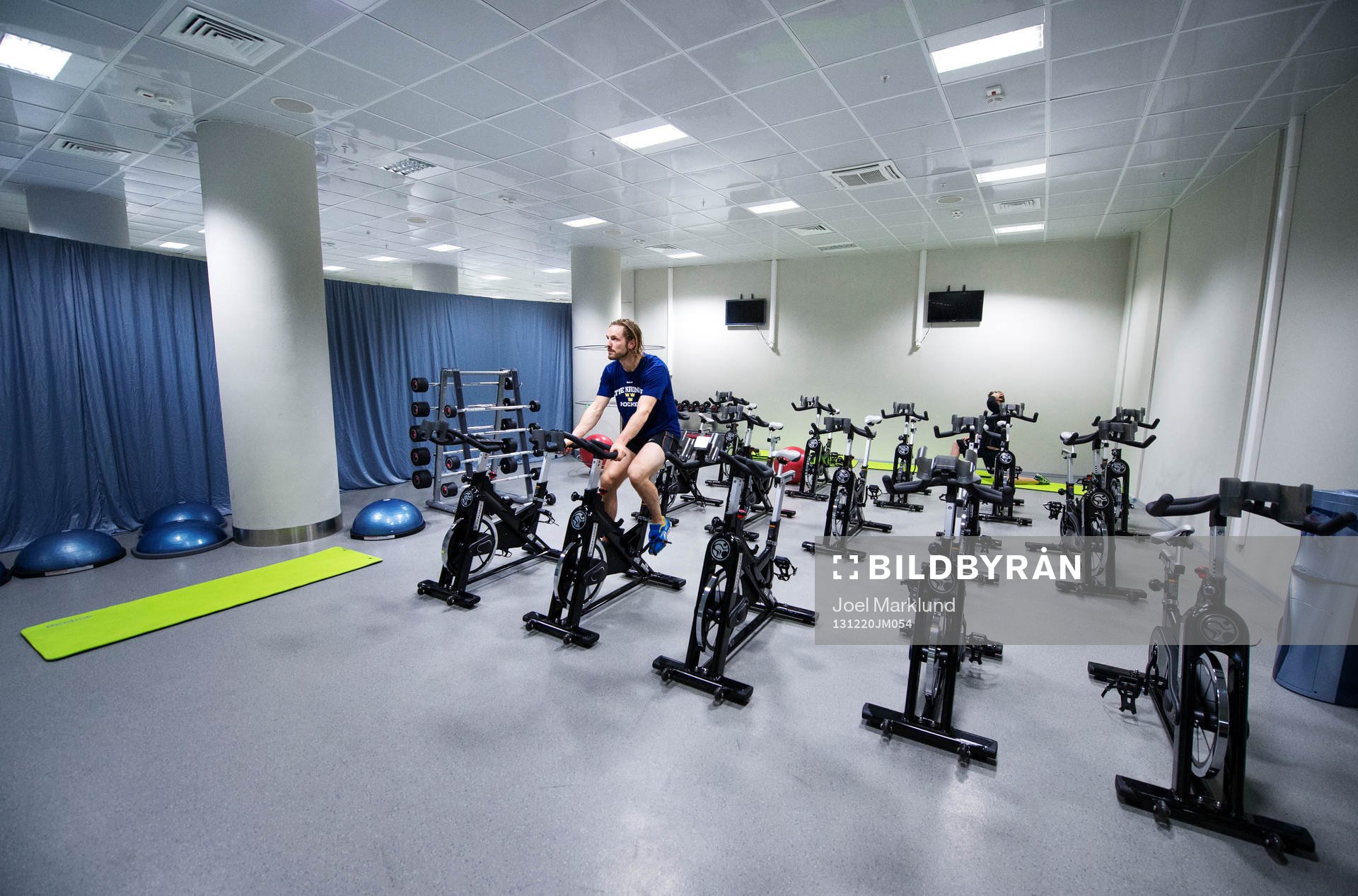 Sveriges Niklas Persson cyklar i ett styrketräningsrum i
