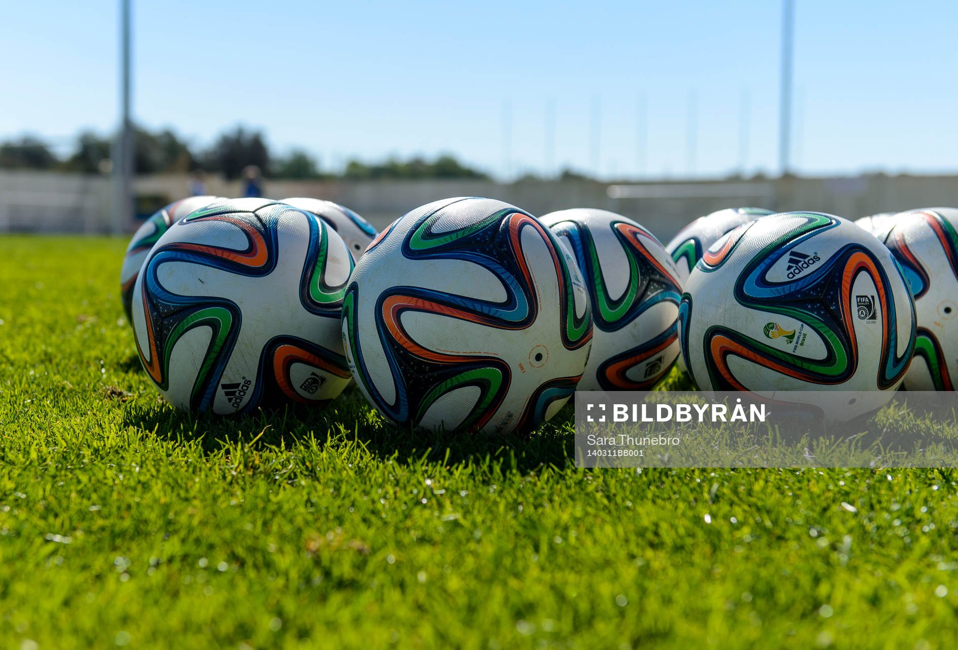 Fotbollar ligger på gräset på en träning