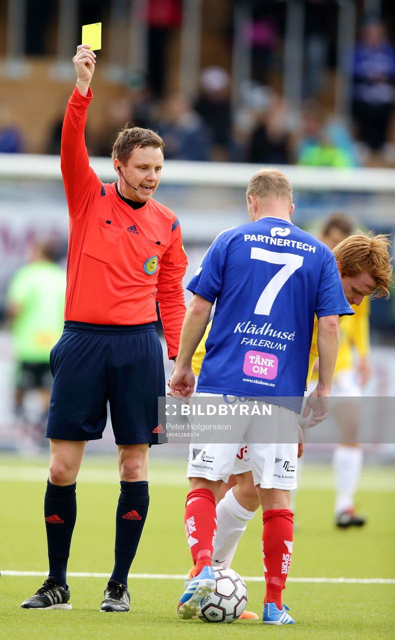 domare Markus Strömbergsson ger varning till Falkenbergs Dan Keat intill Åtvidabergs Kristian Bergström under fotbollsmatchen i allsvenskan mellan Åtvidaberg och Falkenberg den 12 april 2014 i Åtvidaberg.