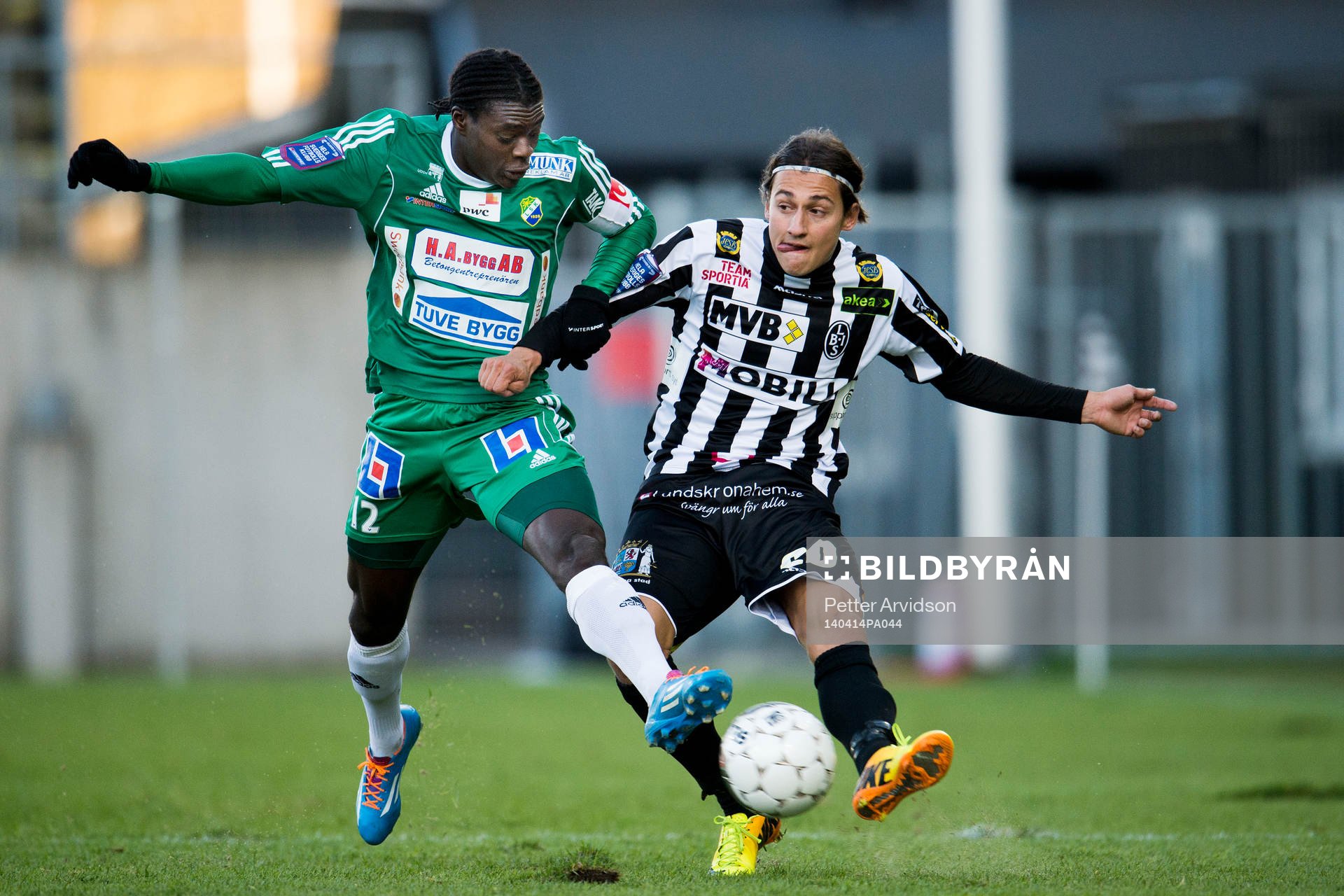 Landskronas Enis Ahmetovic i kamp med Ljungskiles Ken Sema under fotbollsmatchen i Superettan mellan Landskrona BOIS och Ljungskile den 14 april 2014 i Landskrona.