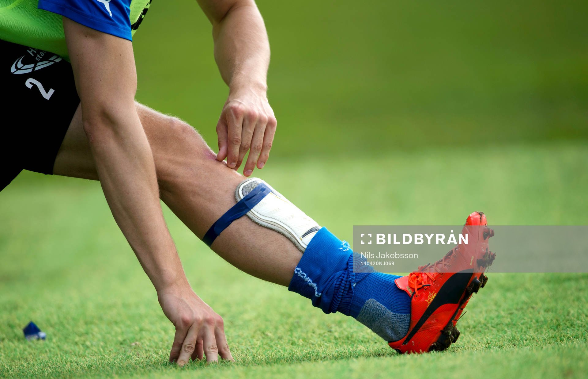 En spelare stretchar under den allsvenska fotbollsmatchen mellan Halmstad och Helsingborg den 20 april 2014 i Halmstad.