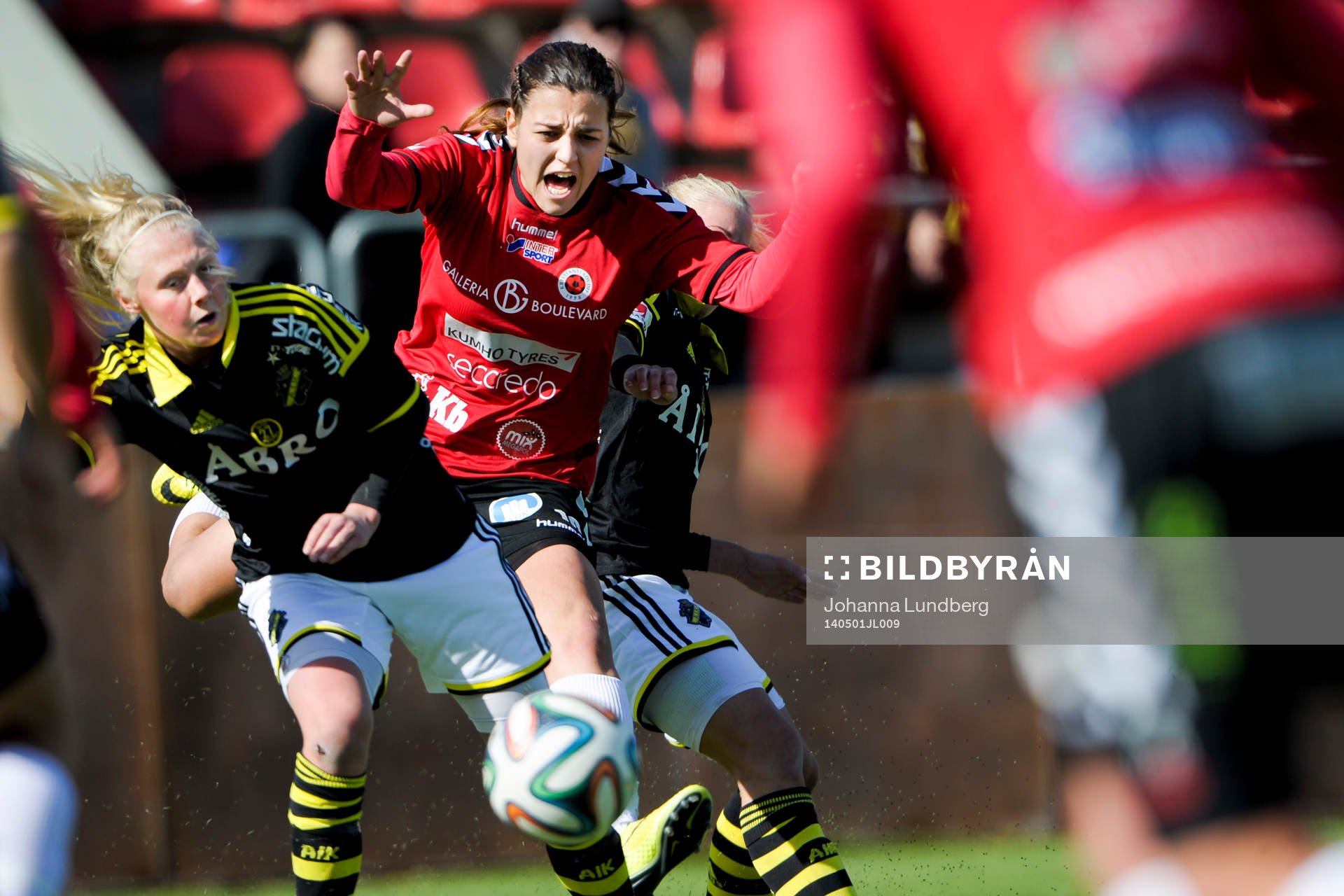 AIKs Elin Bragnum (tv) och Sara Storck (th) i kollision med Kristianstads Marija Banusic under fotbollsmatchen i Damallsvenskan mellan AIK och Kristianstad den 1 maj 2014 i Stockholm.