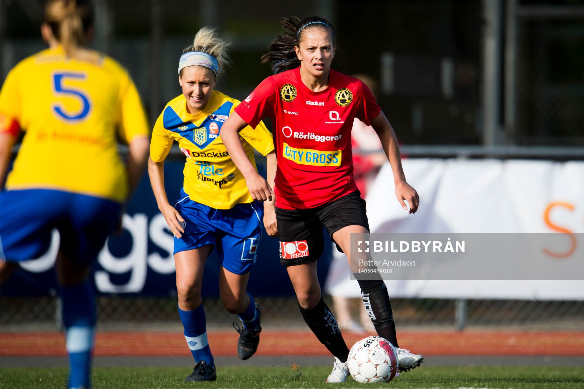 LB07s Josefine Rydle driver fram bollen jagad av Umeå Södras Emma Kullberg under fotbollsmatchen i elitettan mellan LB07 och Umeå Södra den 4 maj 2014 i Malmö.