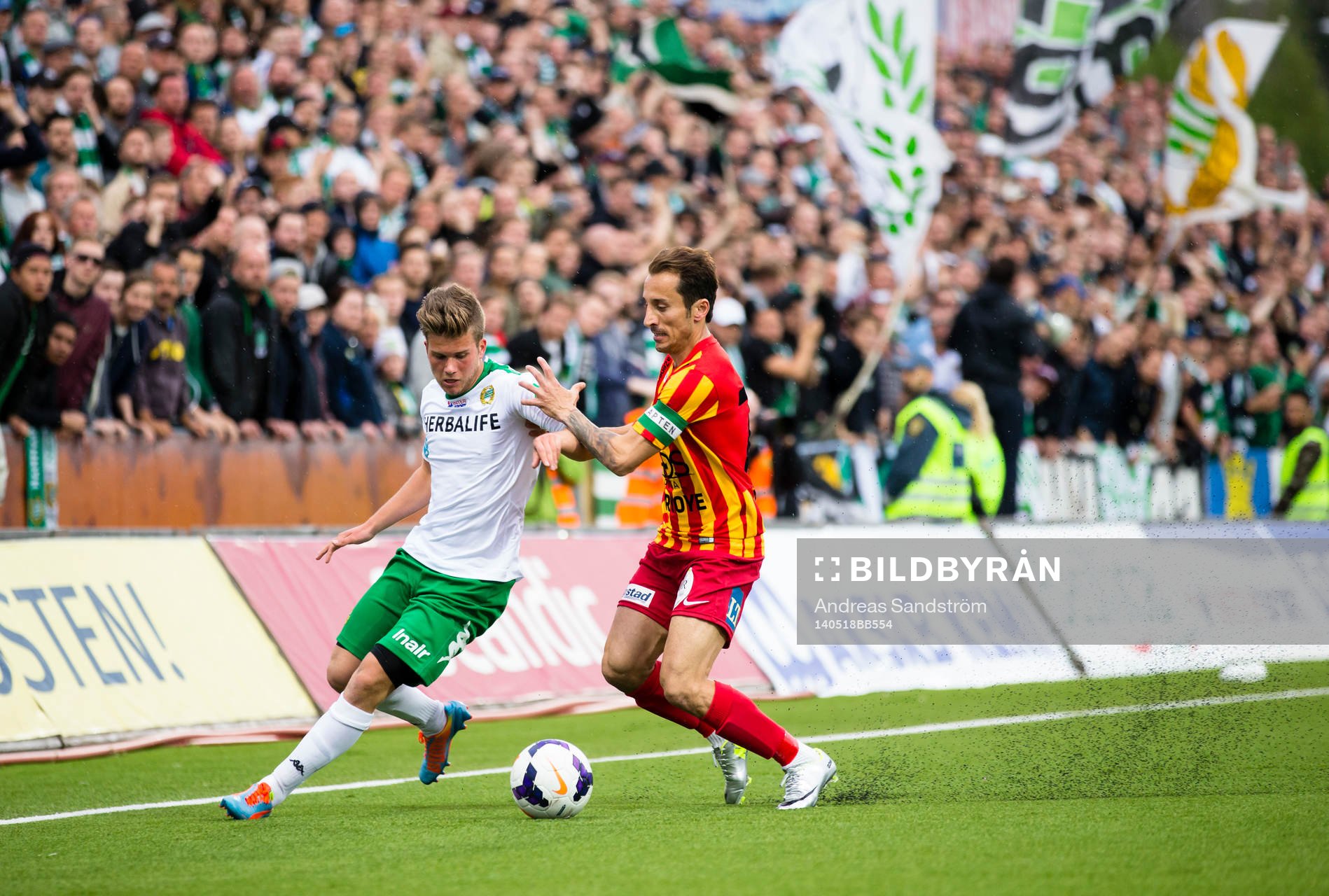Hammarbys Nicklas Lindqvist i kamp med Syrianskas Louay Chanko under fotbollsmatchen i Superettan mellan Syrianska och Hammarby den 18 Maj 2014 i Södertälje.