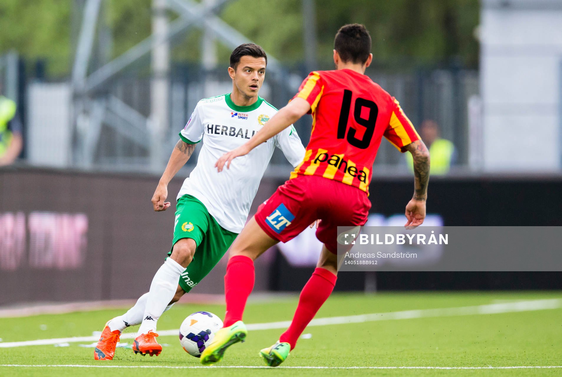 Hammarbys Michael Timisela utmanar Syrianskas Charbel George under fotbollsmatchen i Superettan mellan Syrianska och Hammarby den 18 Maj 2014 i Södertälje. 