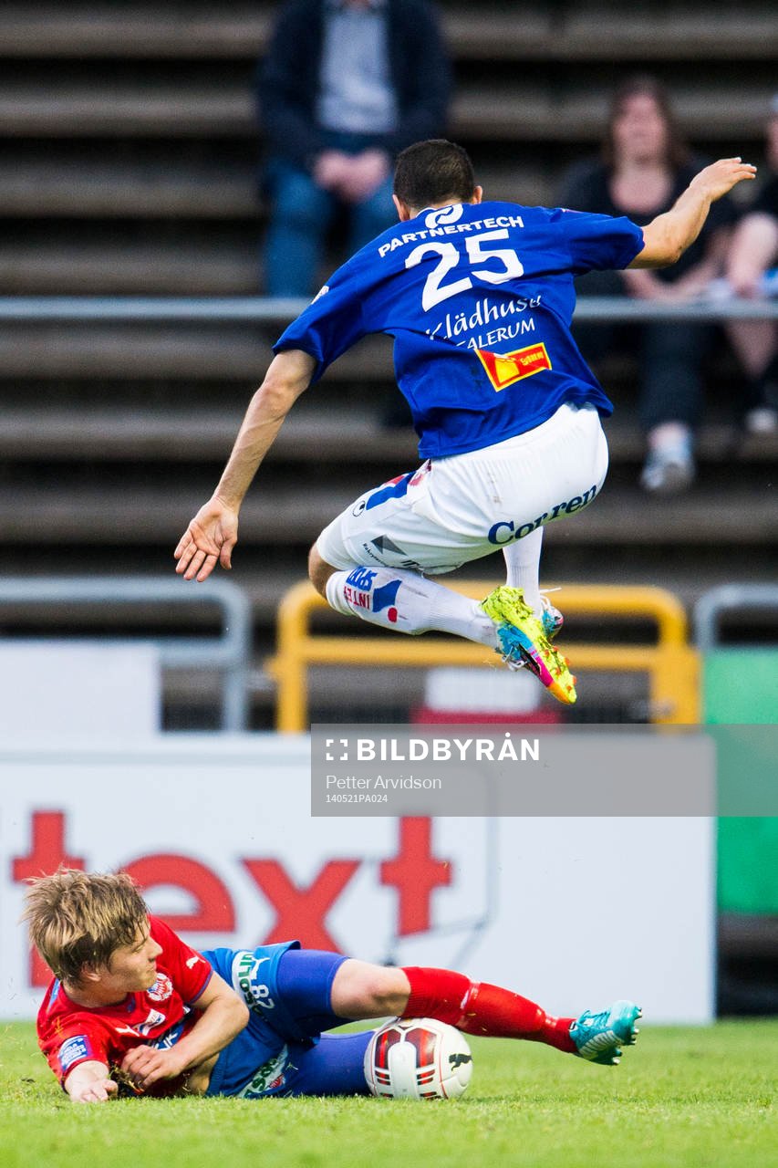 Åtvidabergs Imad Zatara hoppar över Helsingborgs Jere Uronen under den allsvenska fotbollsmatchen mellan Helsingborg och Åtvidaberg den 21 maj 2014 i Helsingborg.