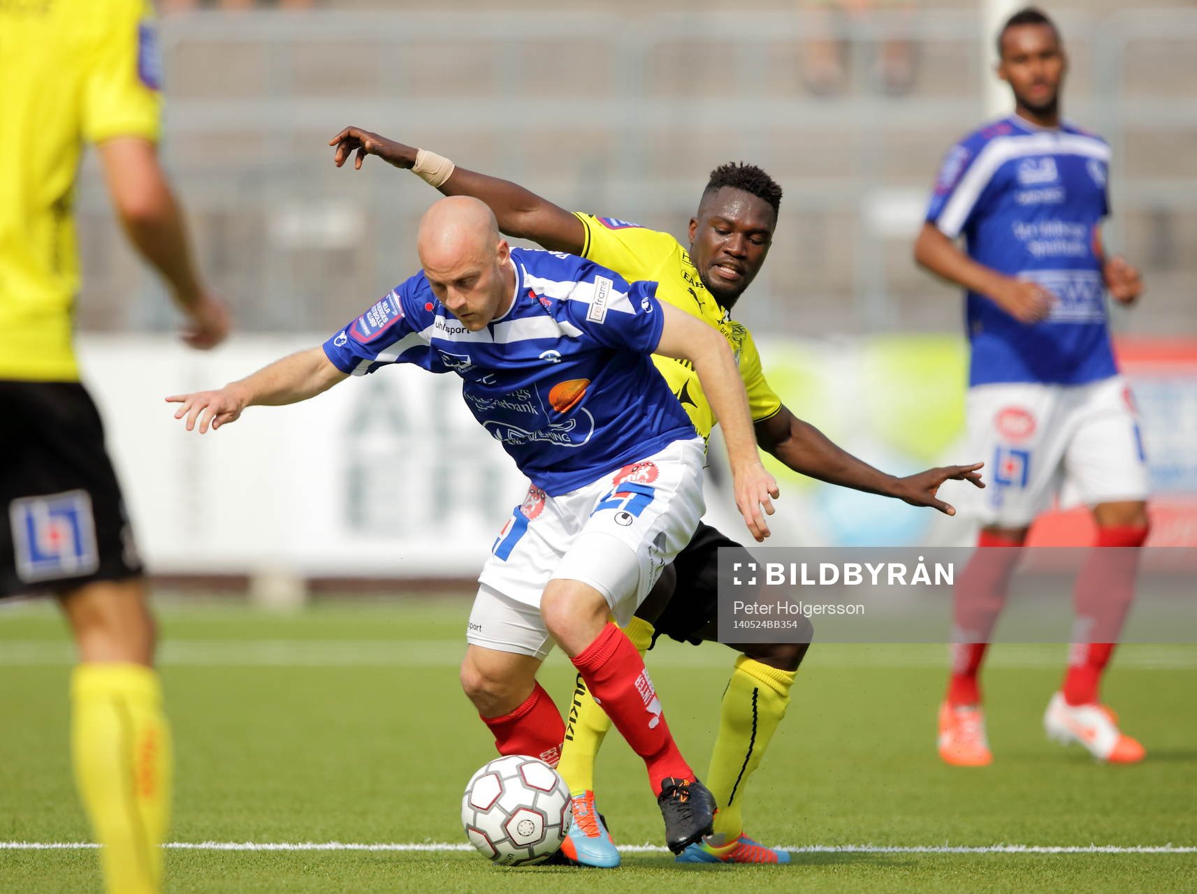 Åtvidabergs Daniel Sjölund och Halmstads King Osei Gyan under fotbollsmatchen i Allsvenskan mellan Åtvidaberg och Halmstad den 12 maj 2014 i Åtvidaberg.
