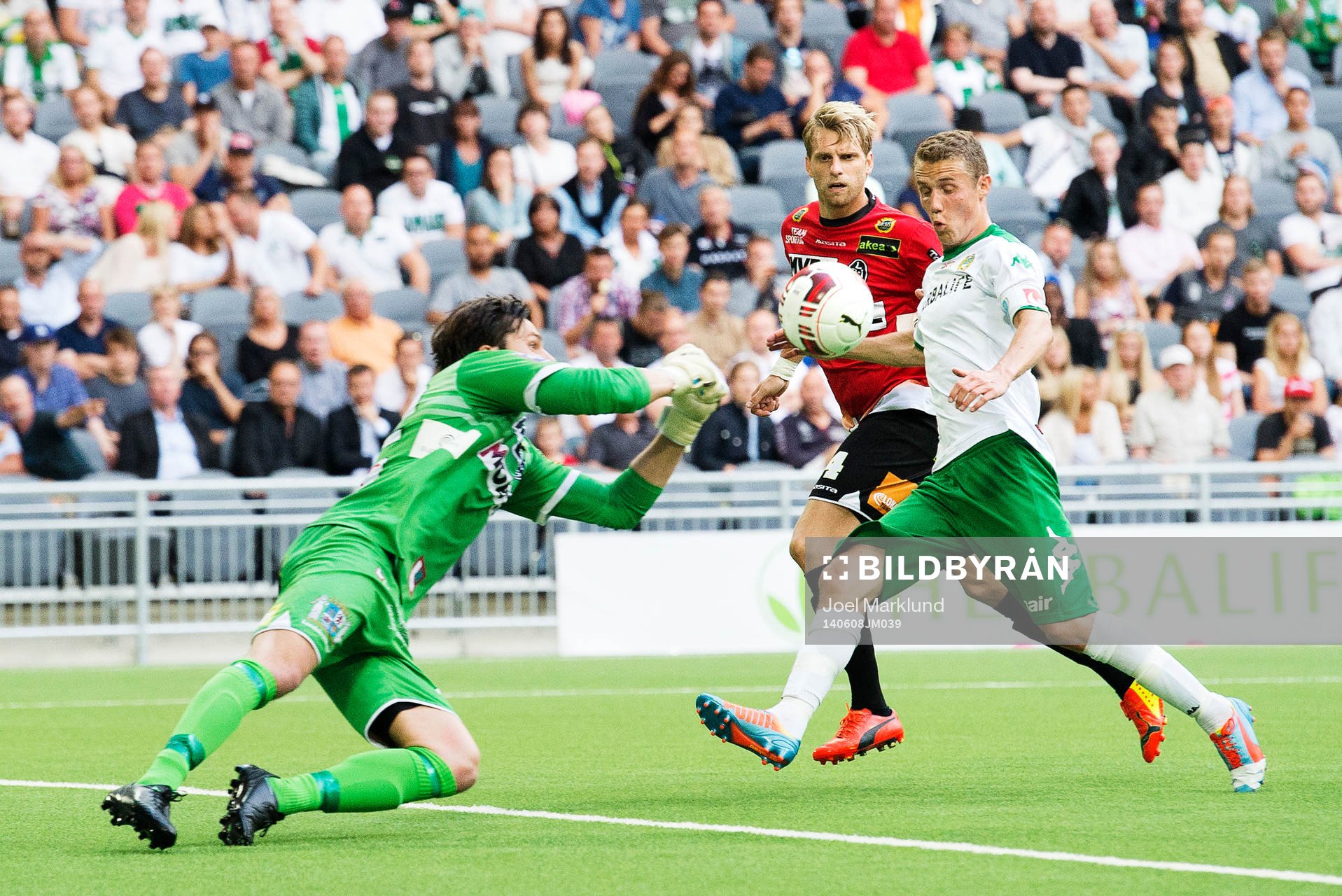 Landskronas målvakt Niklas Uddenäs och Martin Rudolfsson ser till att Hammarbys Fredrik Torsteinbø inte gör mål under fotbollsmatchen i Superettan mellan Hammarby och Landskrona den 8 juni 2014 i Stockholm.