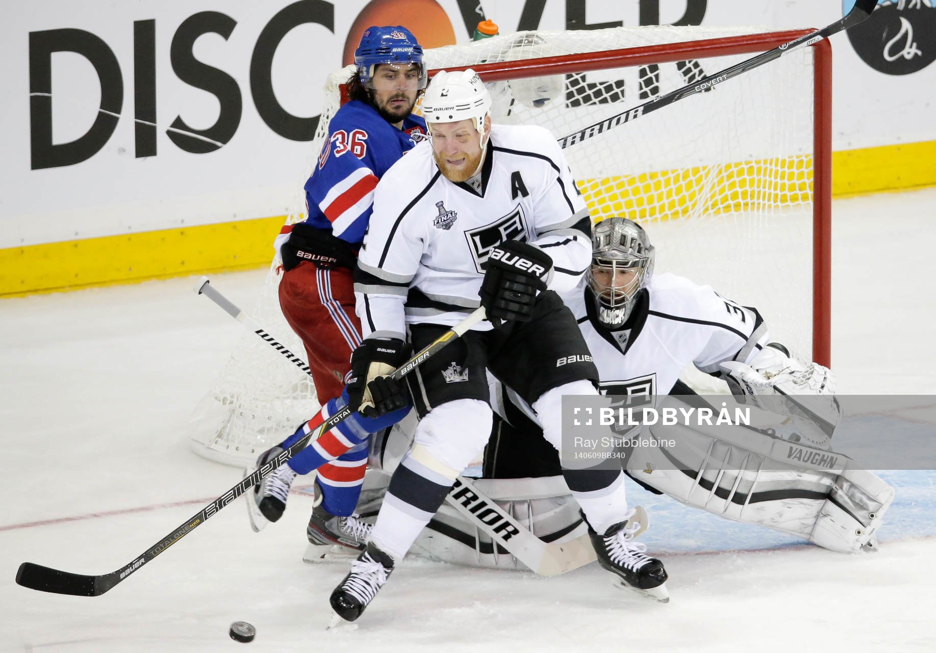 Los Angeles Kings defenseman Matt Greene (C) tries to clear
