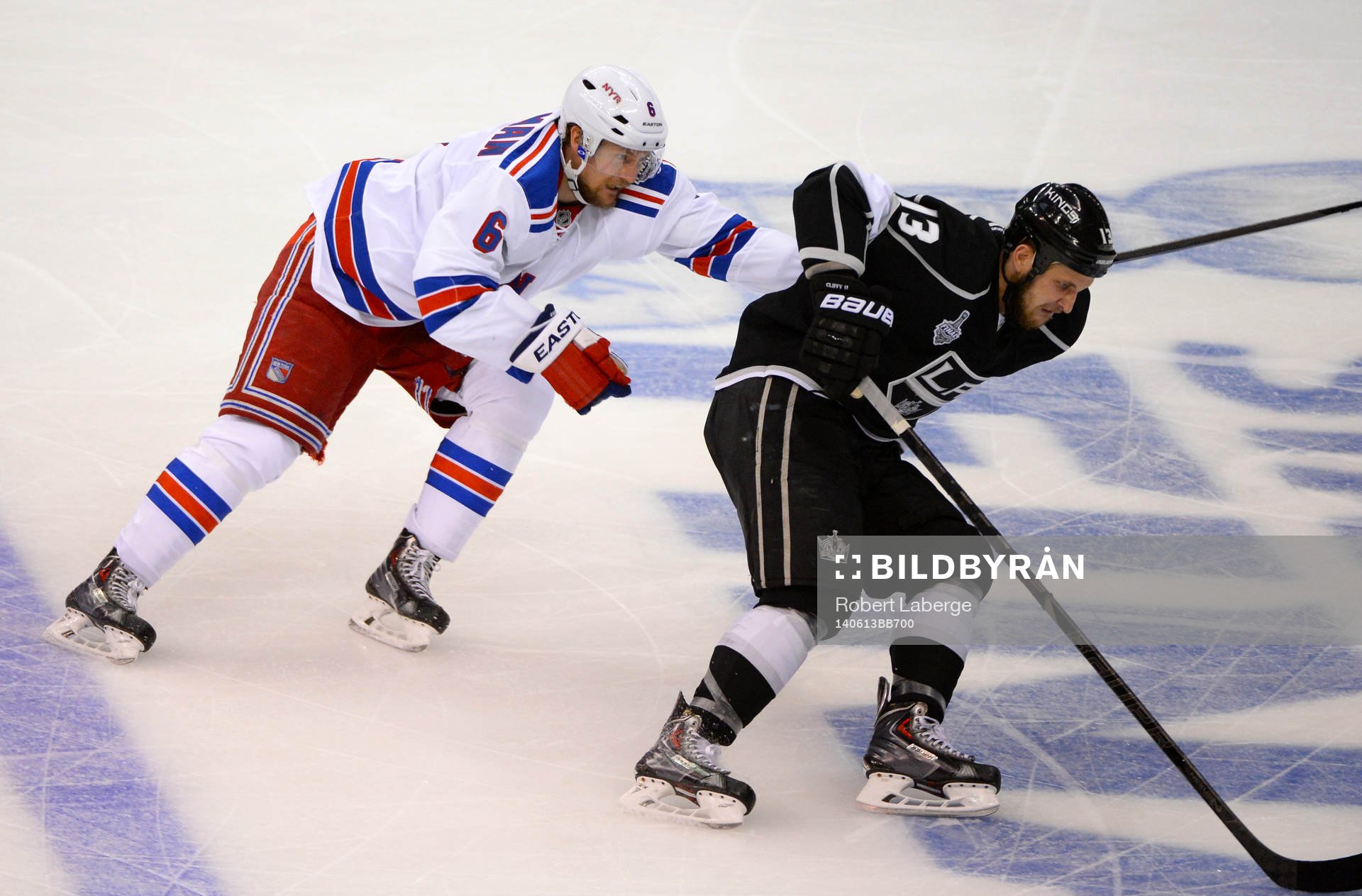 Anton Stralman of the New York Rangers chases Kyle Clifford