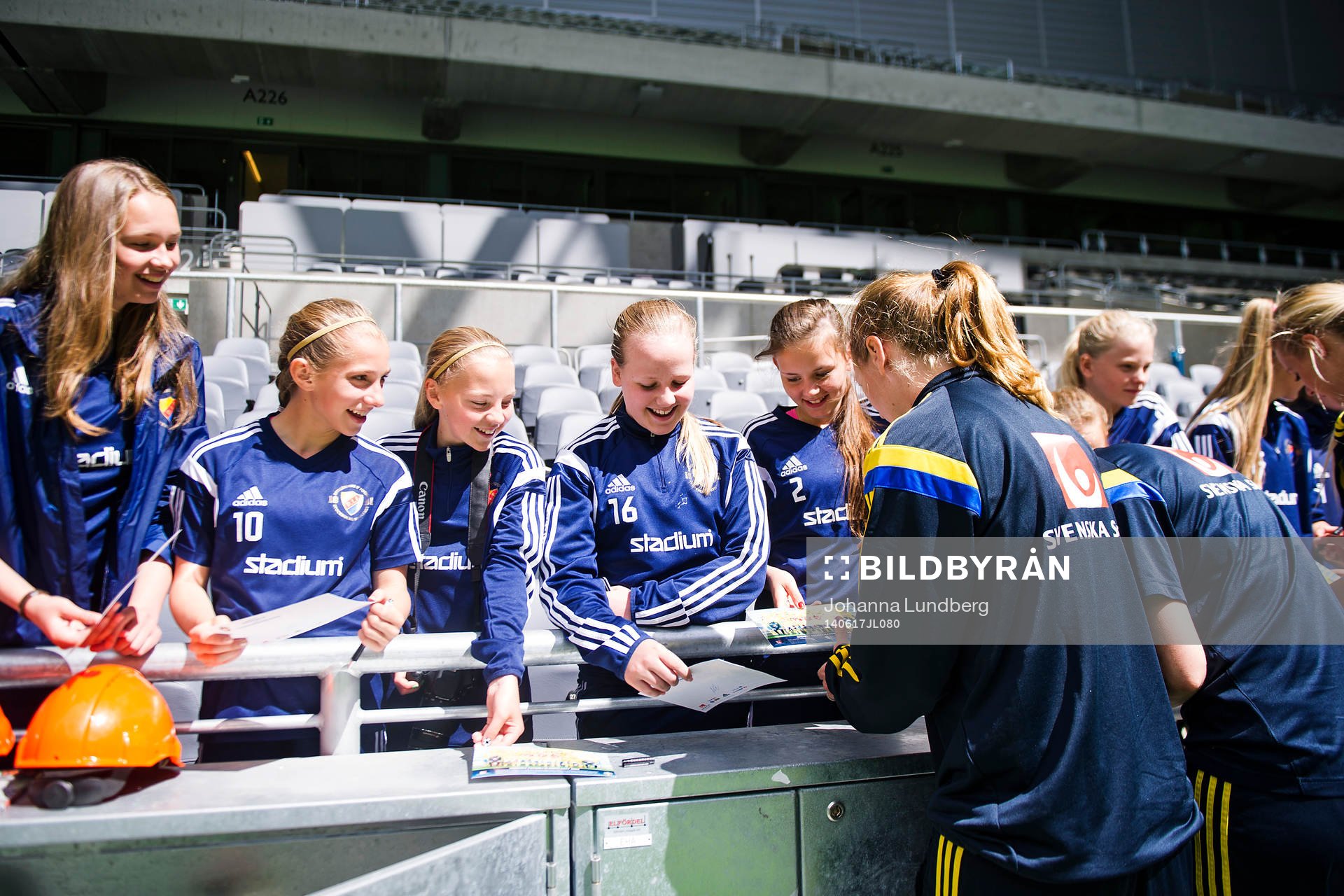 Sveriges spelare skriver autografer åt ett ungdomslag som