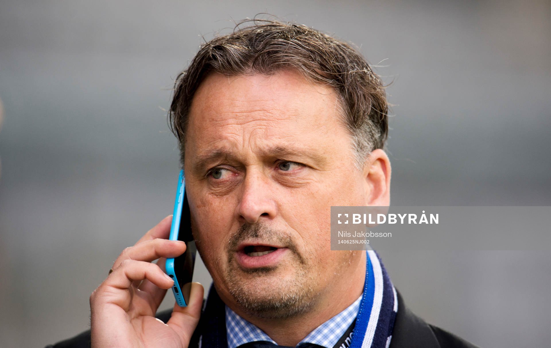GIF Sundsvalls sportchef Urban Hagblom pratar i telefon under fotbollsmatchen i superettan mellan Landskrona BOIS och GIF Sundsvall den 25 juni 2014 i Landskrona.