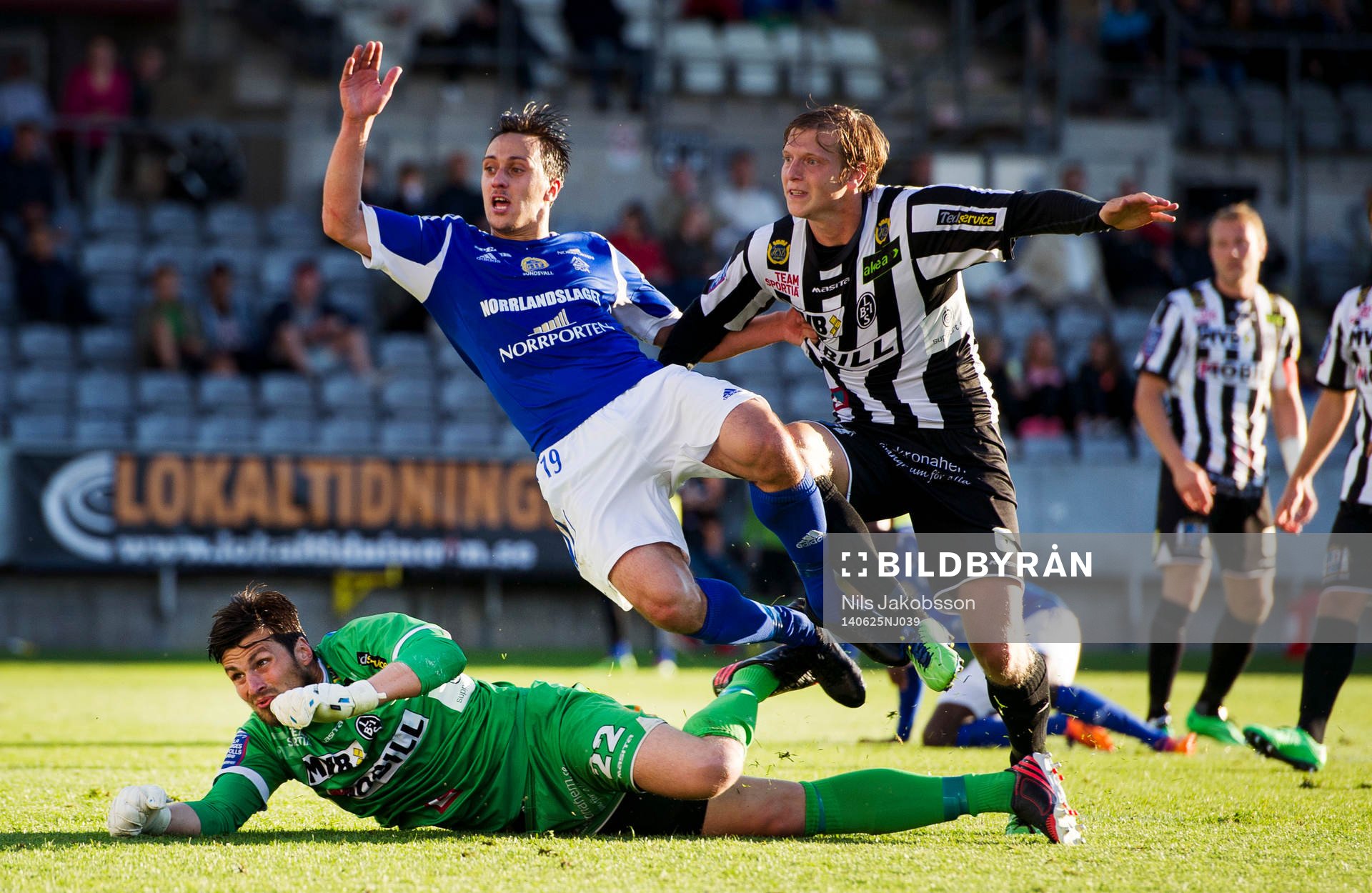 Landskronas målvakt Niklas Uddenäs och Philip Andersson i duell med GIF Sundsvalls Adam Chennoufi under fotbollsmatchen i superettan mellan Landskrona BOIS och GIF Sundsvall den 25 juni 2014 i Landskrona.