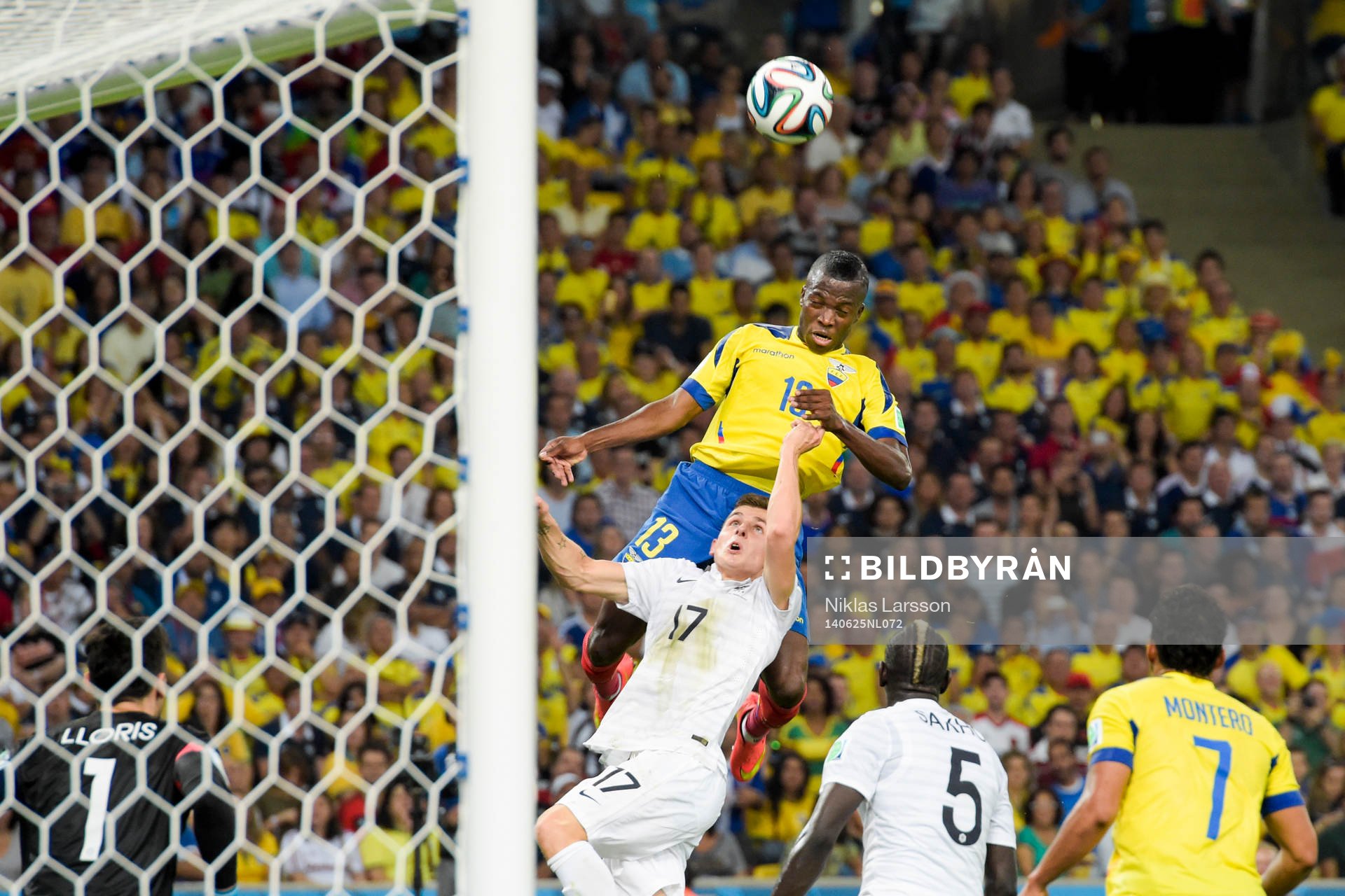 Ecuadors Enner Valencia är nära att nicka bollen i mål när han når högre än Frankrikes Lucas Digne under fotbollsmatchen mellan Frankrike och Ecuador under fotbolls-VM den 25 juni 2014 i Rio de Janeiro.