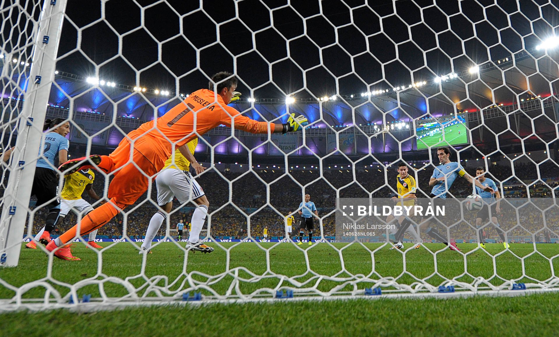 Colombias James Rodriguez gör 2-0 målet bakom Uruguays målvakt Fernando Muslera under fotbollsmatchen mellan Colombia och Uruguay under fotbolls-VM den 28 juni 2014 i Rio de Janeiro.