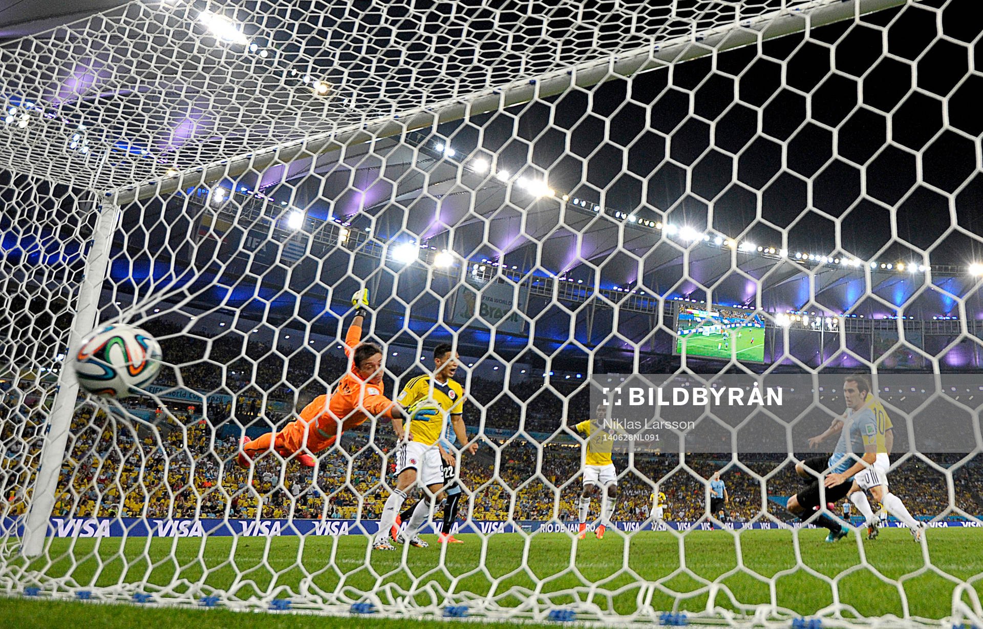 Colombias James Rodriguez gör 2-0 målet bakom Uruguays målvakt Fernando Muslera under fotbollsmatchen mellan Colombia och Uruguay under fotbolls-VM den 28 juni 2014 i Rio de Janeiro.