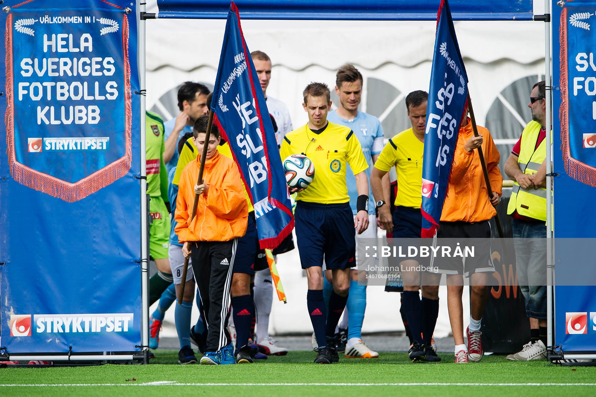 Spelare och domarteam går in på planen