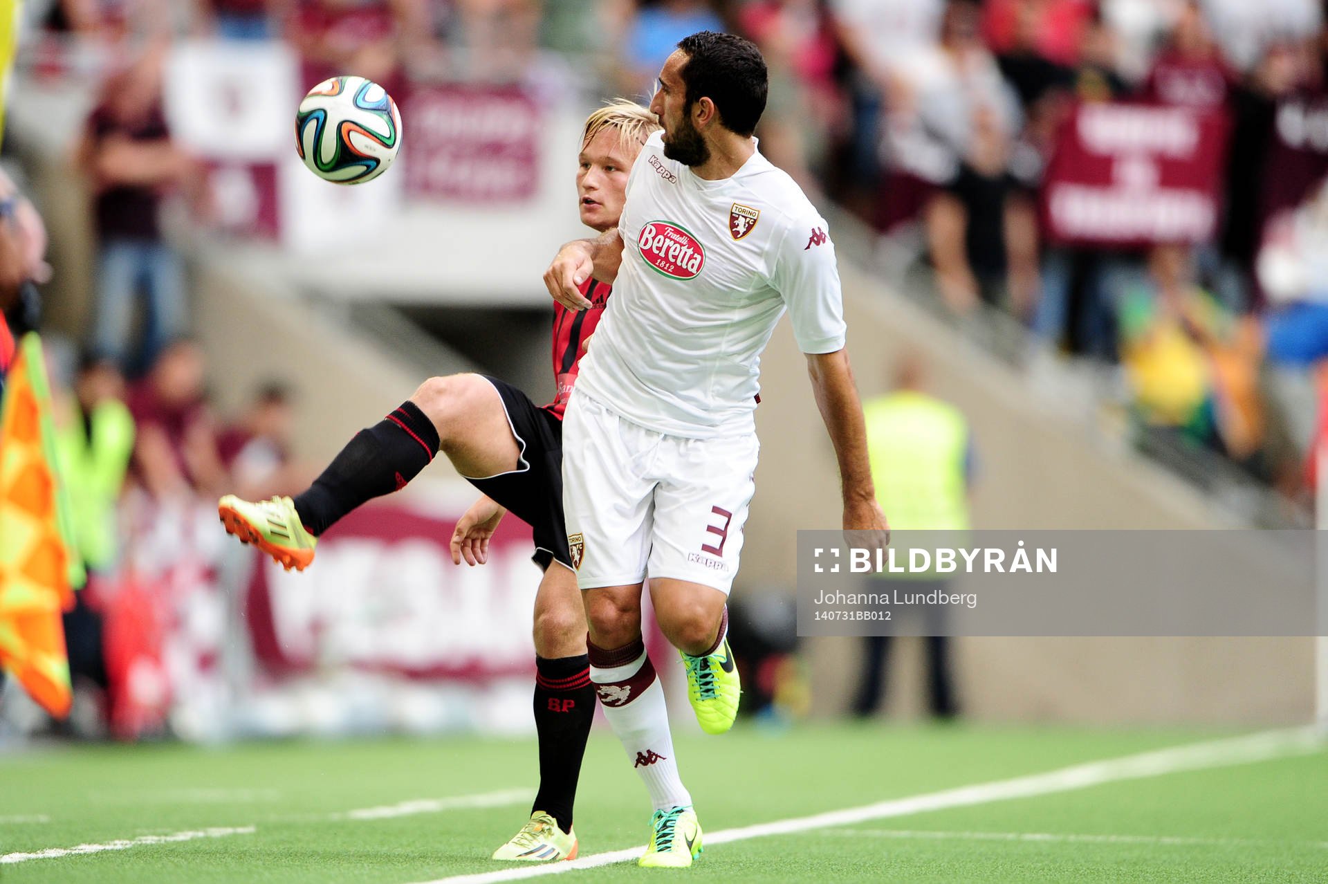 Brommapojkarnas Nicklas Bärkroth och Torinos Cristian Molinaro under fotbollsmatchen i kvalet till Europa League mellan Brommapojkarna och Torino den 30 juli 2014 i Stockholm.