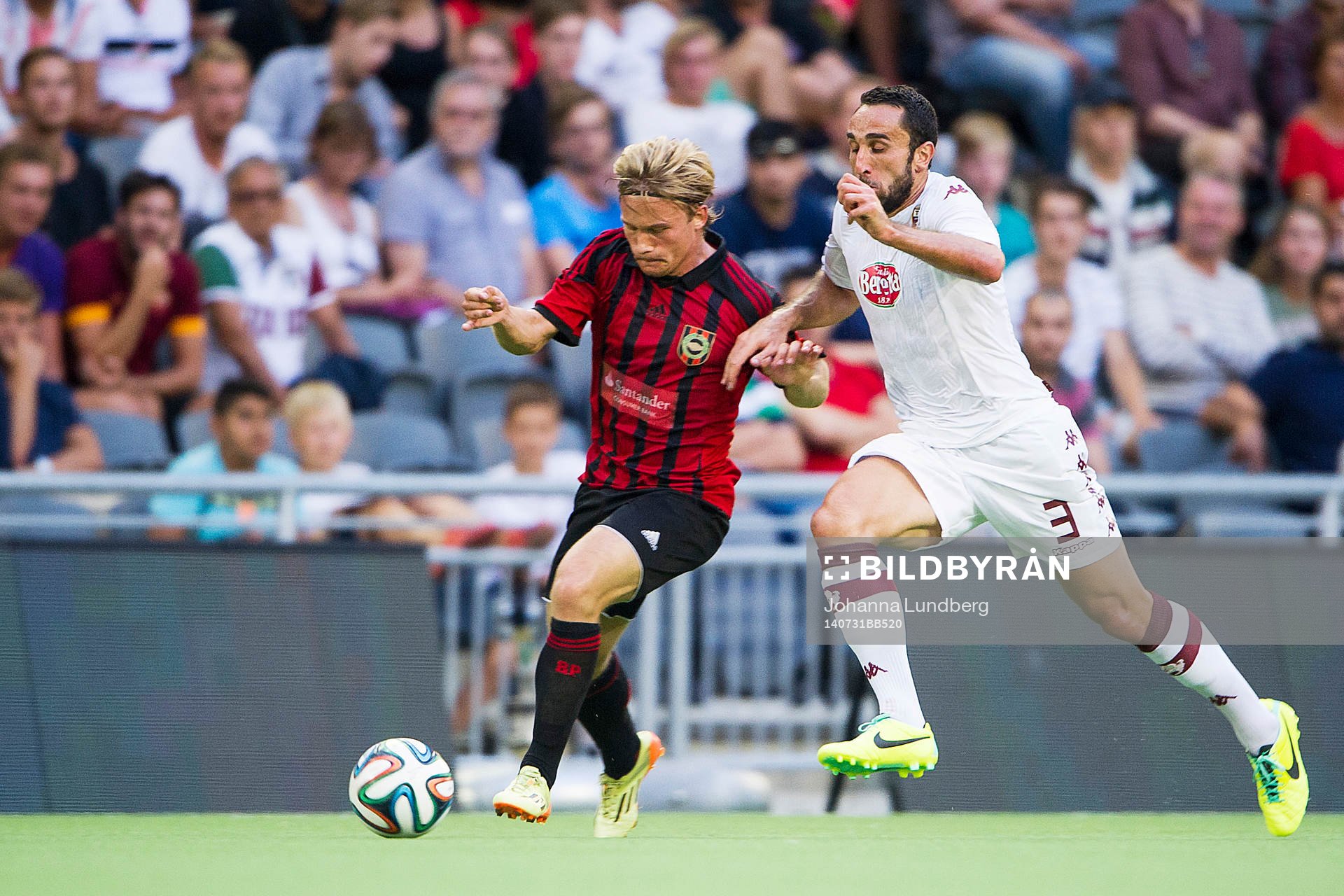 Brommapojkarnas Nicklas Bärkroth mot Torinos Cristian Molinaro under fotbollsmatchen i kvalet till Europa League mellan Brommapojkarna och Torino den 30 juli 2014 i Stockholm.