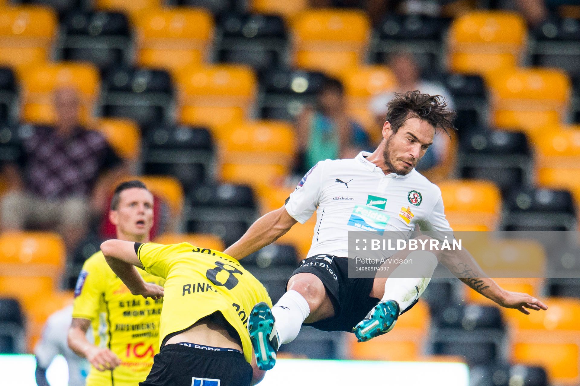 Örebros Nordin Gerzic åker på en lufttur efter duell med Mjällbys Robin Strömberg under fotbollsmatchen i Allsvenskan mellan Mjällby och Örebro den 9 augusti 2014 i Mjällby.