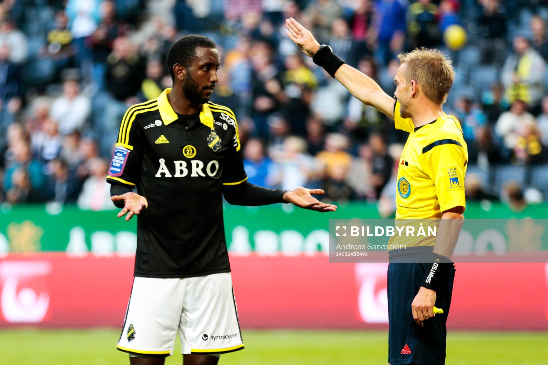 AIK:s Henok Goitom samtalar med Johan Hamlin, domare under fotbollsmatchen i Allsvenskan mellan AIK och BK Häcken den 24 Augusti 2014 i Stockholm.