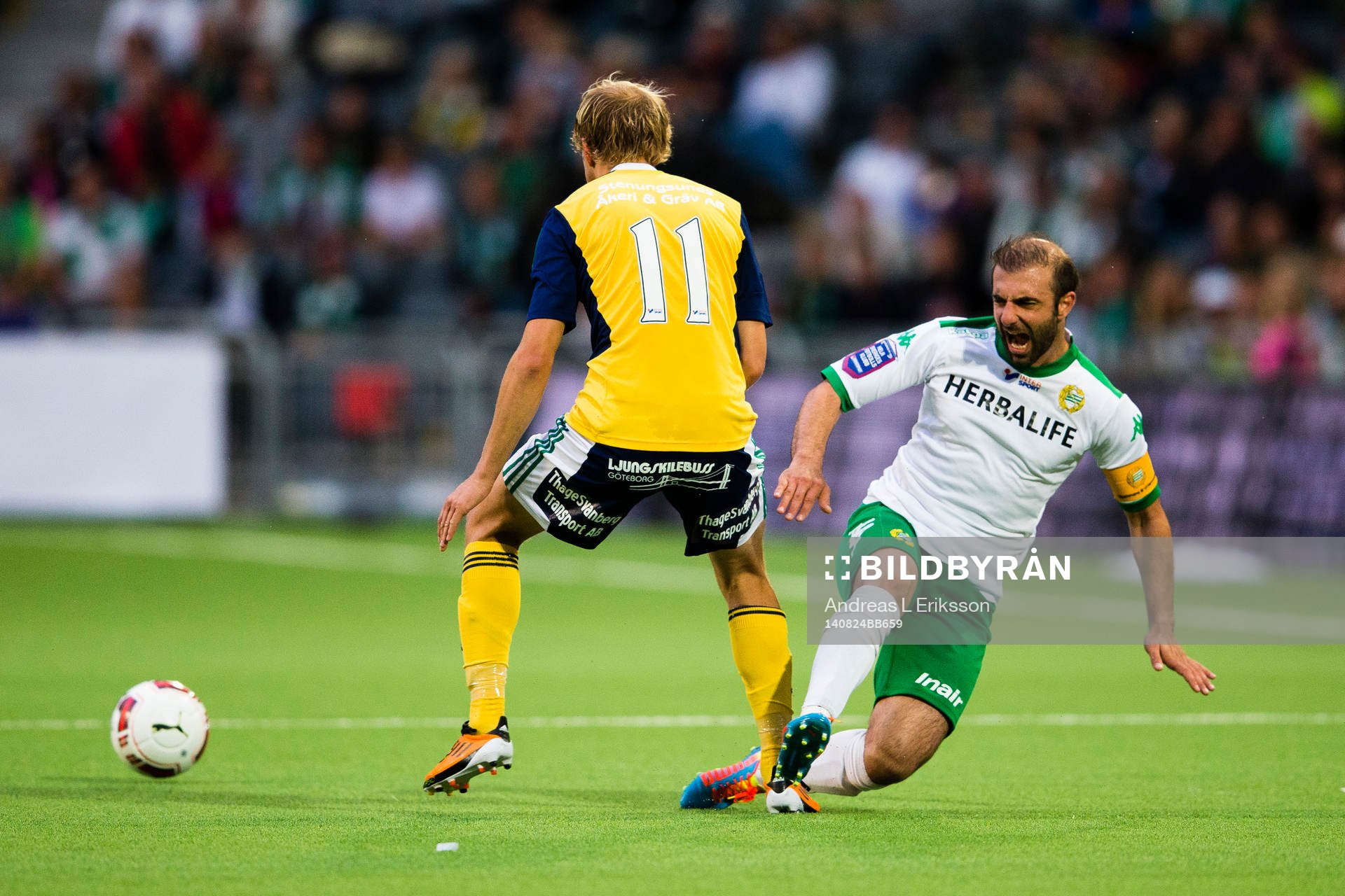 Ljungskiles Jakob Olsson stoppar Hammarbys Kennedy Bakircioglu under fotbollsmatchen i Superettan mellan Hammarby och Ljungskile den 24 augusti 2014 i Stockholm.