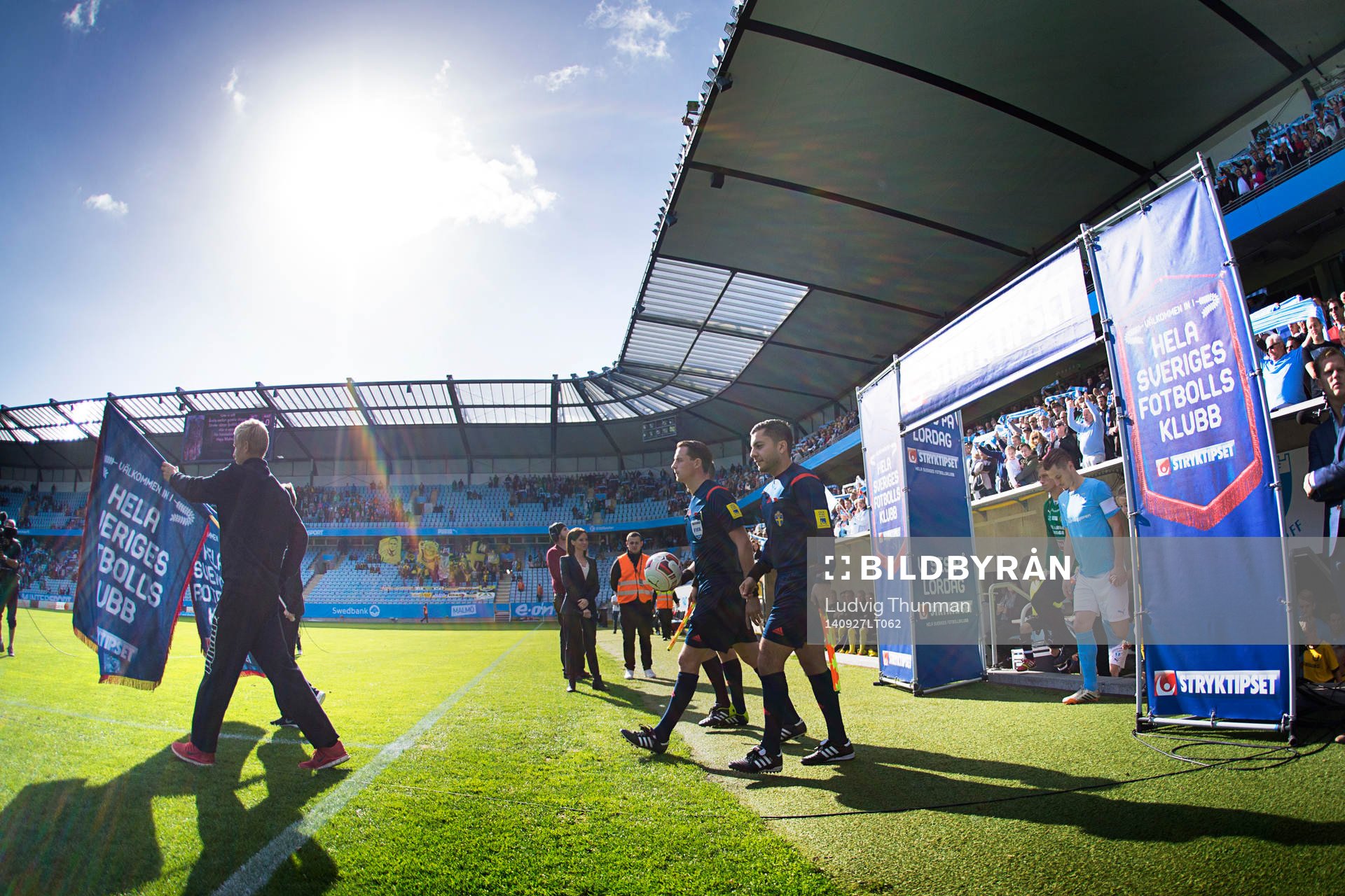 Domarna och spelarna kommer in på planen inför matchen i Allsvenskan mellan Malmö FF och Mjällby den 27 september 2014 i Malmö. 