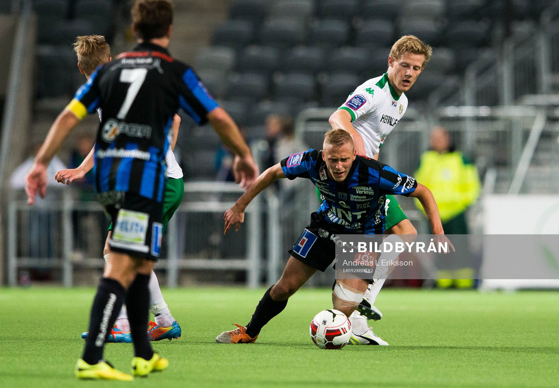 Sirius Christer Gustafsson går omkull i en närkamp med Hammarbys Lars Sætra under fotbollsmatchen i Superettan mellan Hammarby och Sirius den 28 september 2014 i Stockholm.