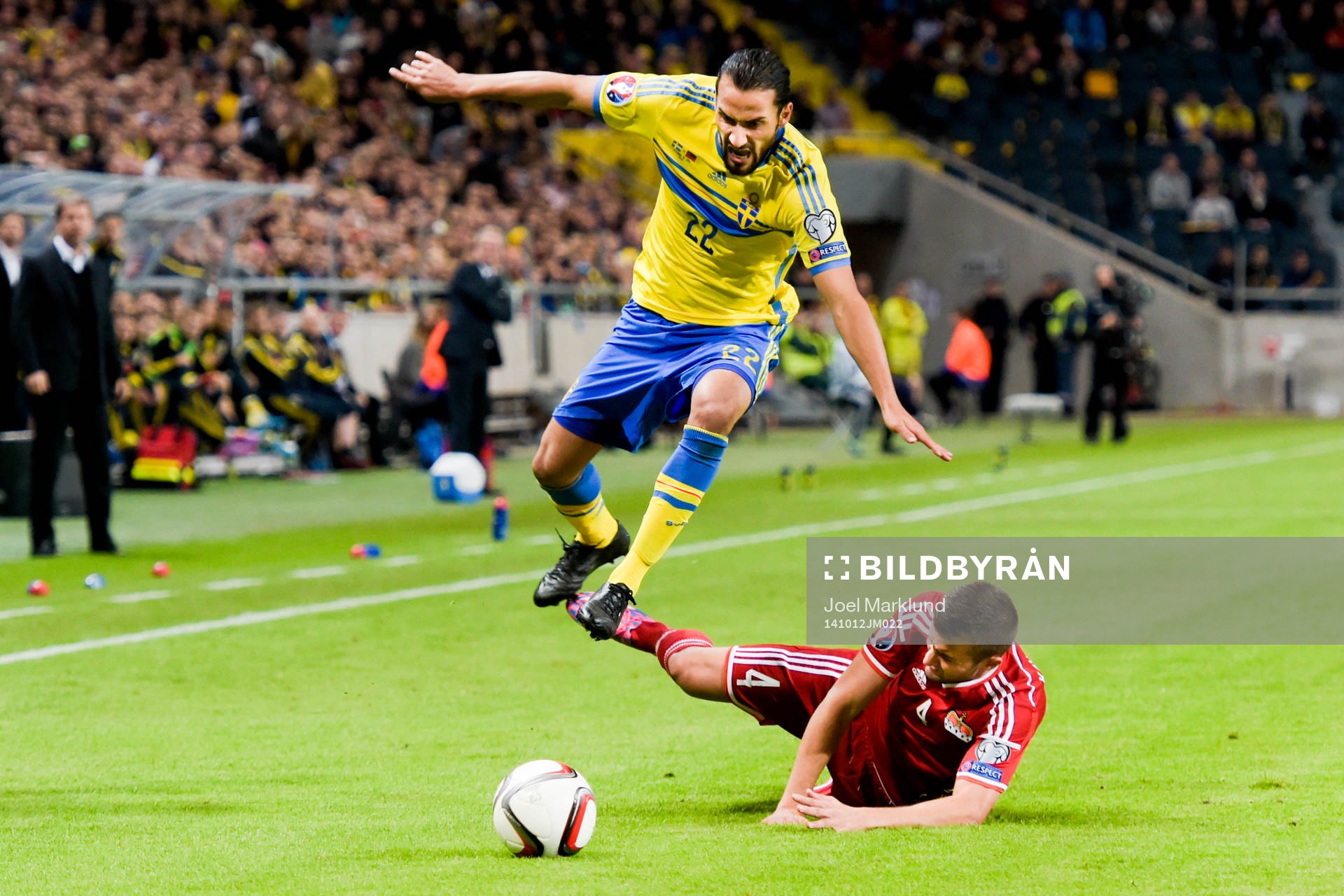 Sveriges Erkan Zengin hoppar över Liechtensteins Daniel Kaufmann under fotbollsmatchen i EM-kvalet mellan Sverige och Liechtenstein den 12 oktober 2014 i Stockholm.