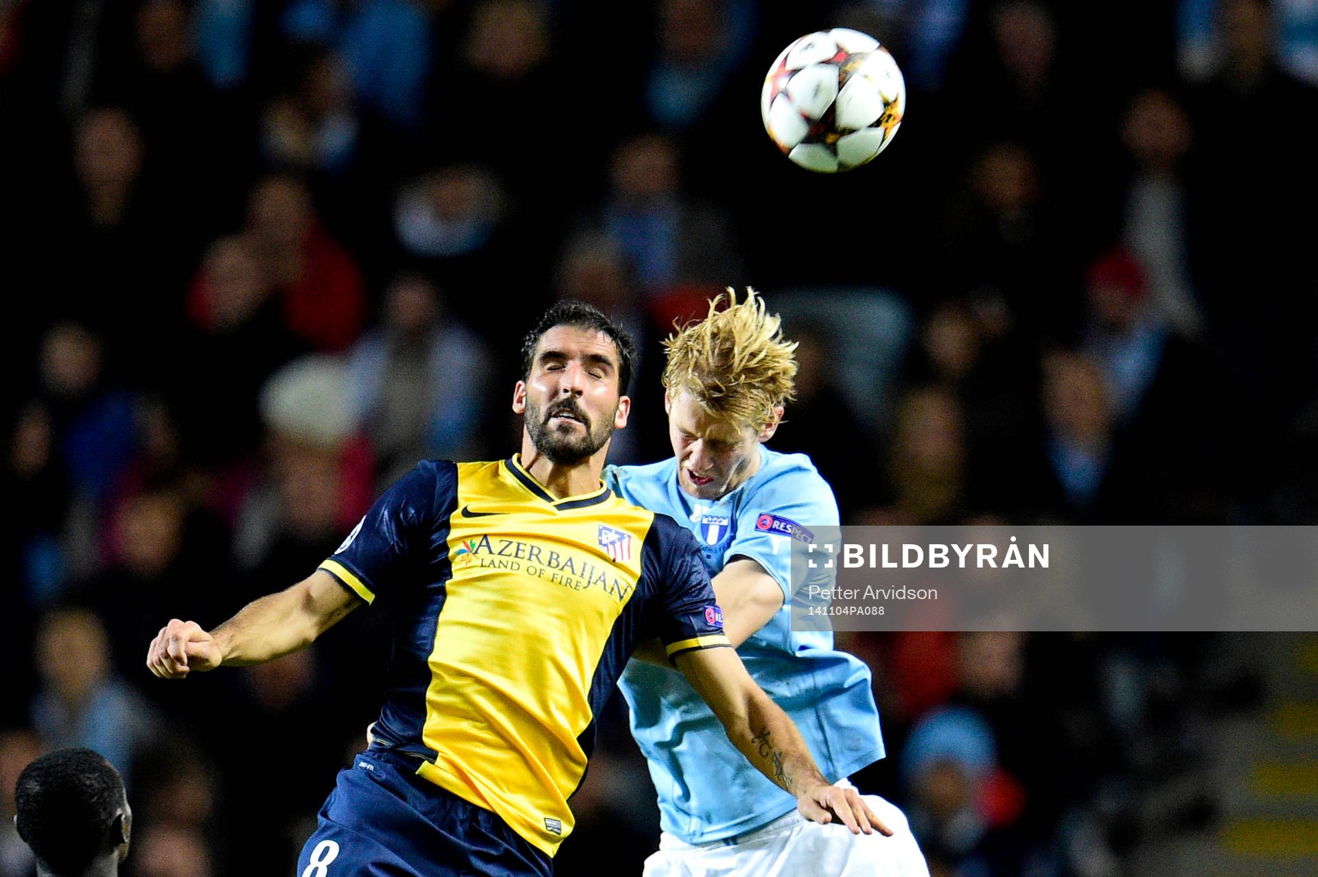 Atletico Madrids Raul Garcia och Malmö FF:s Filip Helander under fotbollsmatchen i Champions League mellan Malmö FF och Atlético Madrid den 4 november 2014 i Malmö. 
