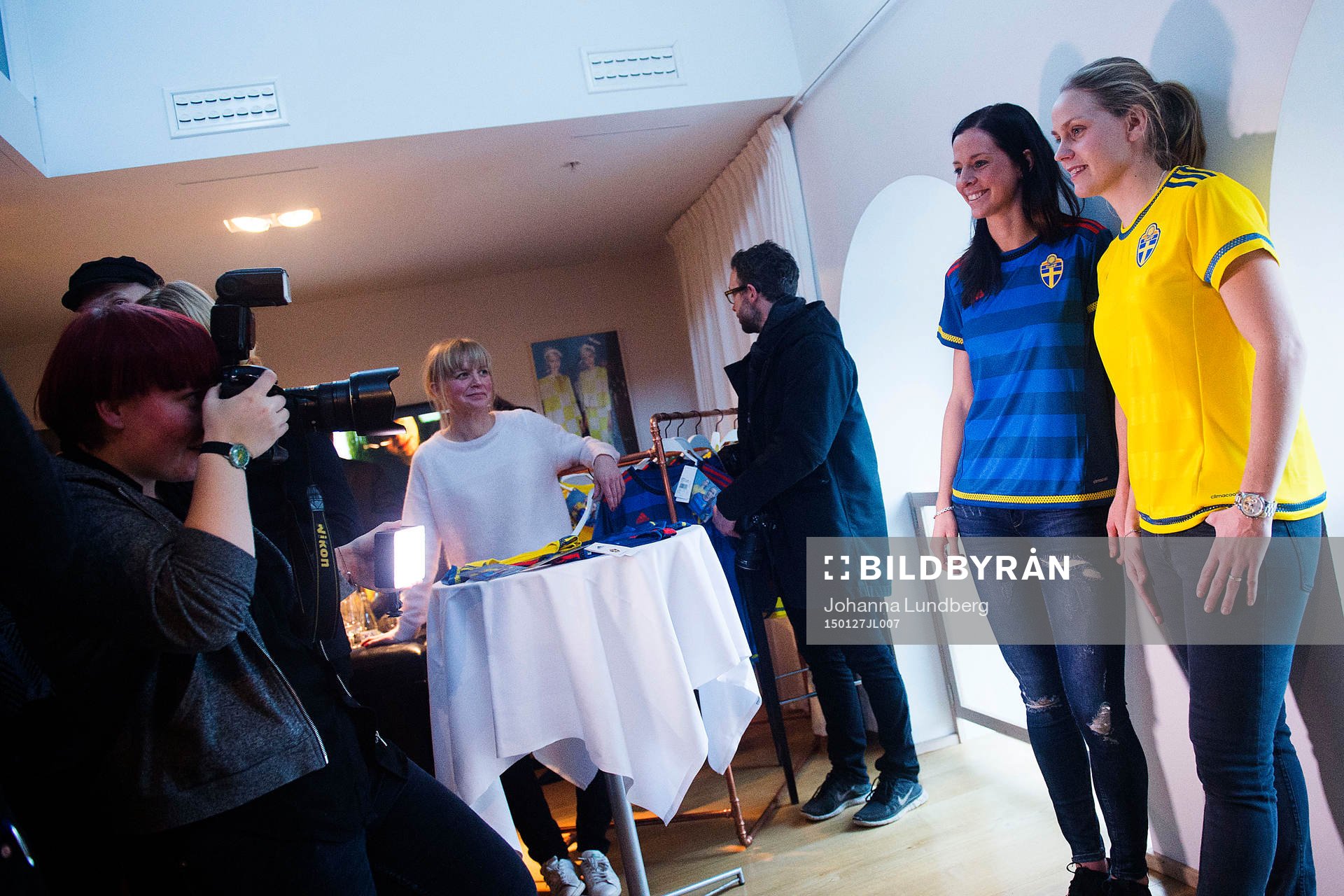 Lotta Schelin och Lisa Dahlkvist blir fotograferade under en presskonferens där landslagets nya tröja presenteras av adidas den 27 januari 2015 i Stockholm.