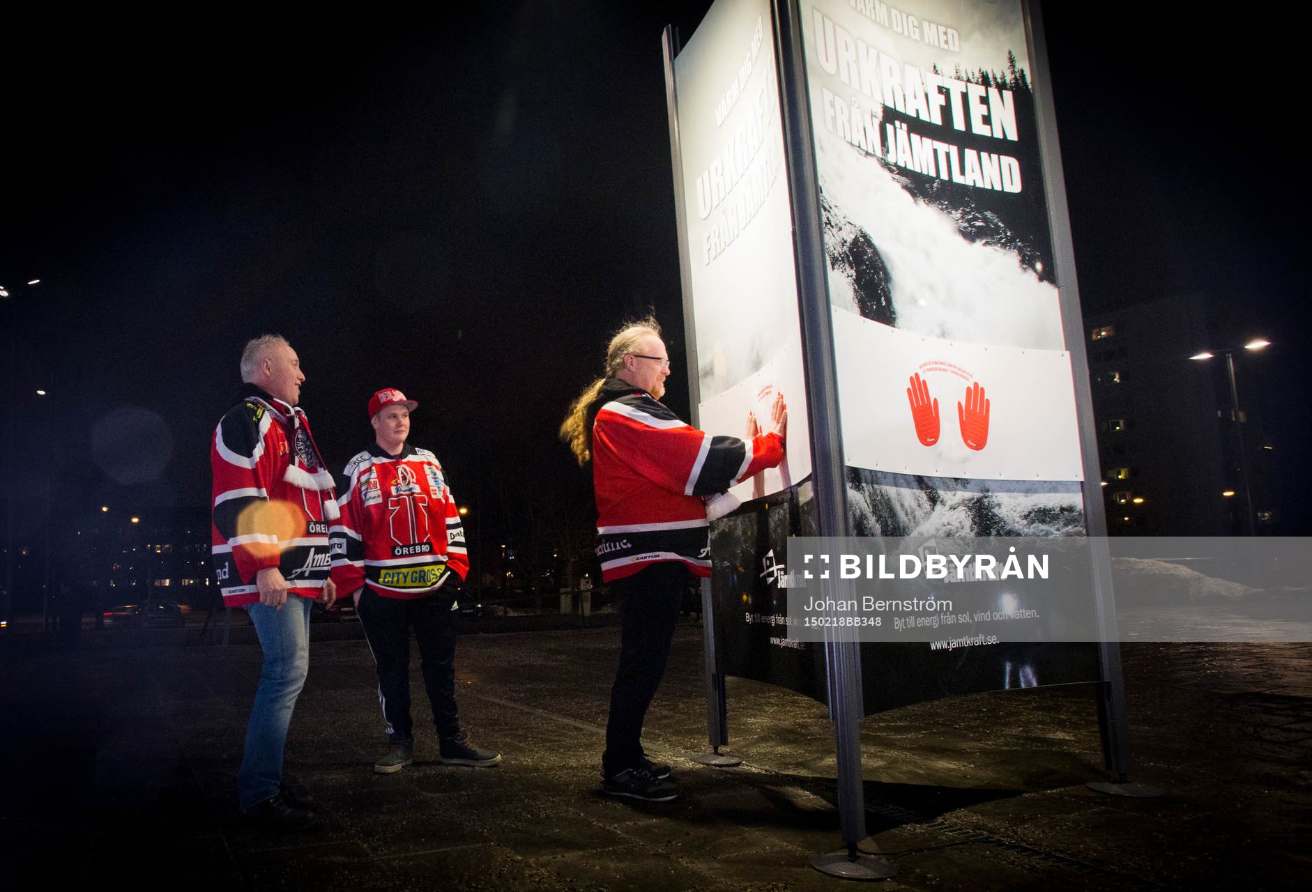 Örebro supportar värmer sig på Jämtkraft reklamskylt