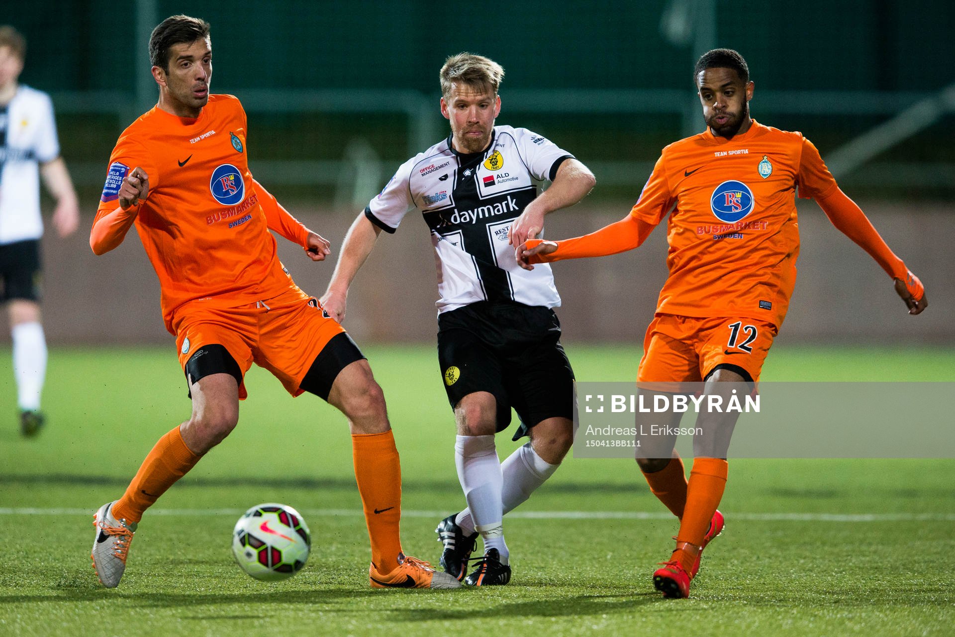 Athletics Uros Delic (v) och Yassuf Saleh (h) försvarar sig mot Frej Täbys Joakim Runnemo under fotbollsmatchen i Superettan mellan Athletic och Frej Täby den 13 april 2014 i Stockholm.
