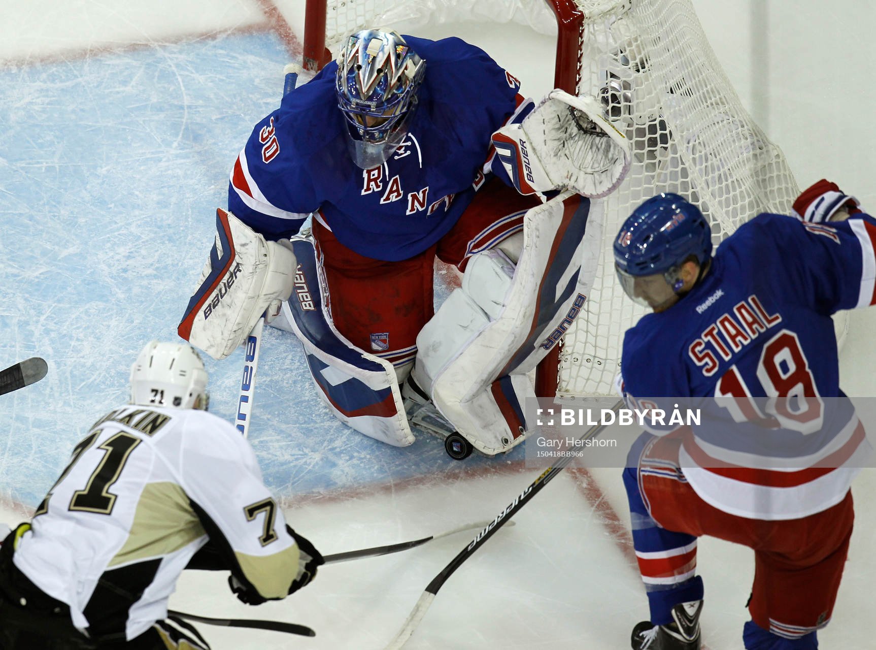 New York Rangers goalie Henrik Lundqvist (C) makes a skate