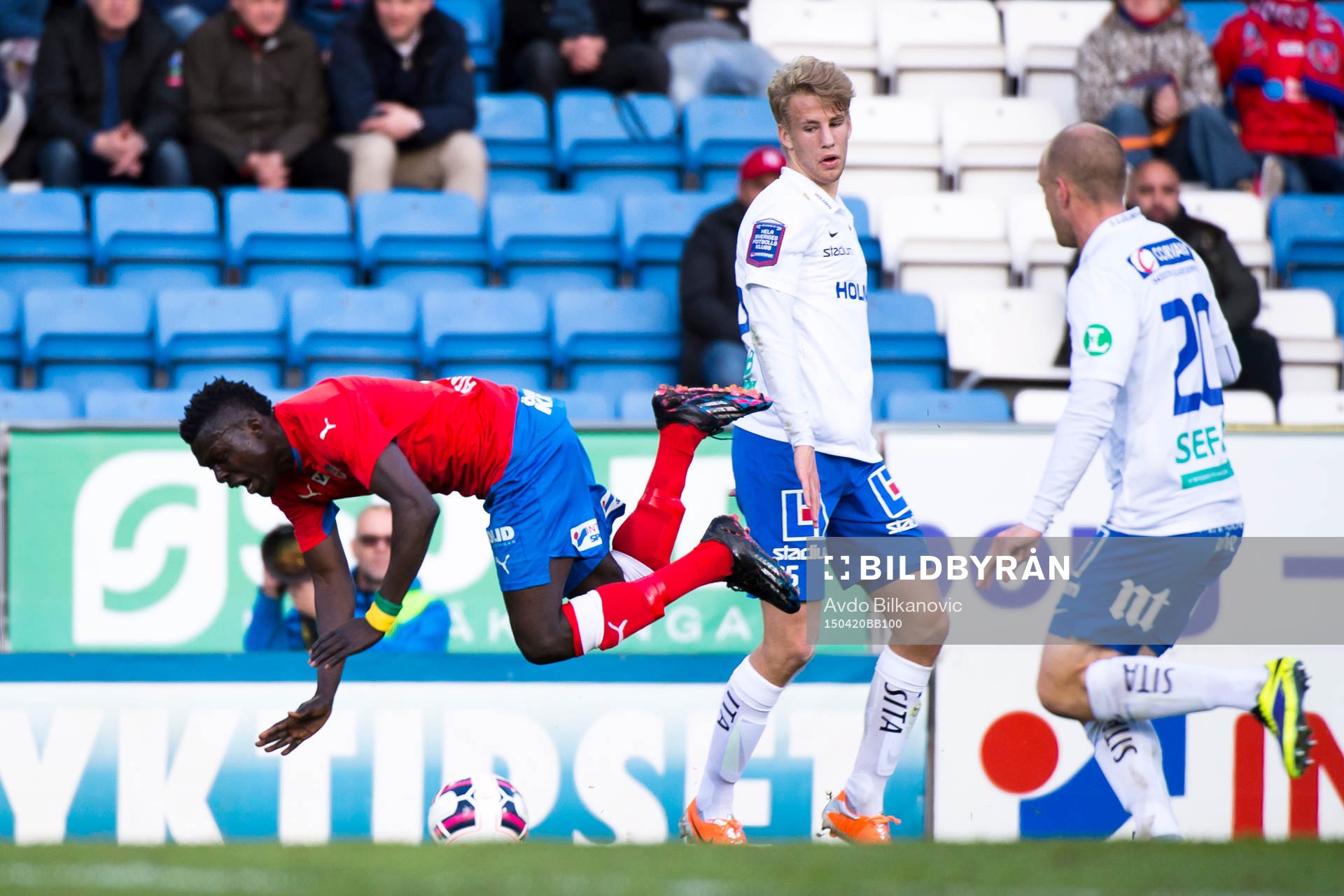 Helsingborgs Lalawélé Atakora fälls av Norrköpings Christoffer Nyman under fotbollsmatchen i Allsvenskan mellan Helsingborg och Norrköping den 20 april 2015 i Helsingborg