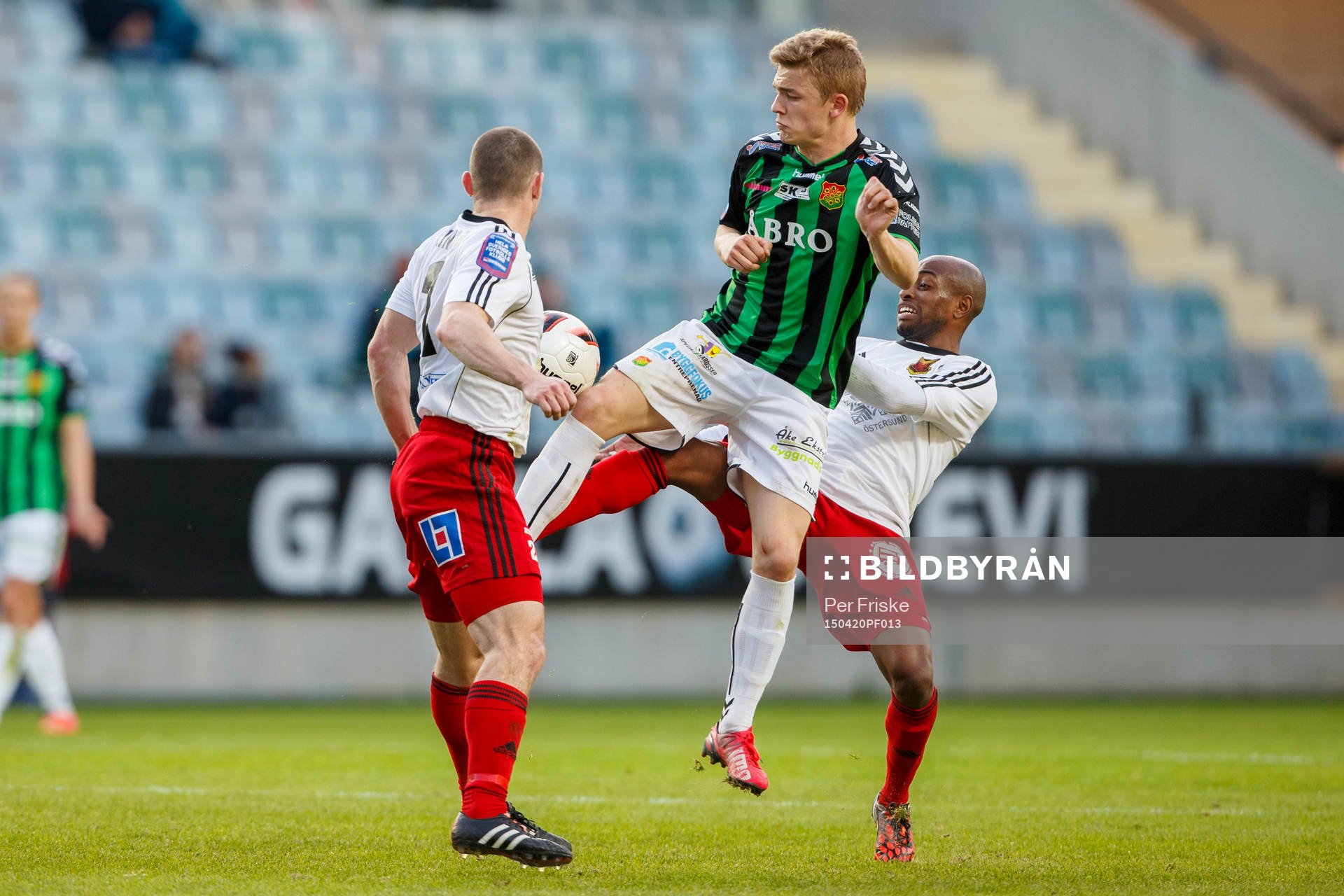 Gais Adam Eriksson i kamp om bollen med Östersunds James Sinclair och Östersunds Fouad Bachirou under fotbollsmatchen i Superettan mellan Gais och Östersund den 20 april 2015 i Göteborg.