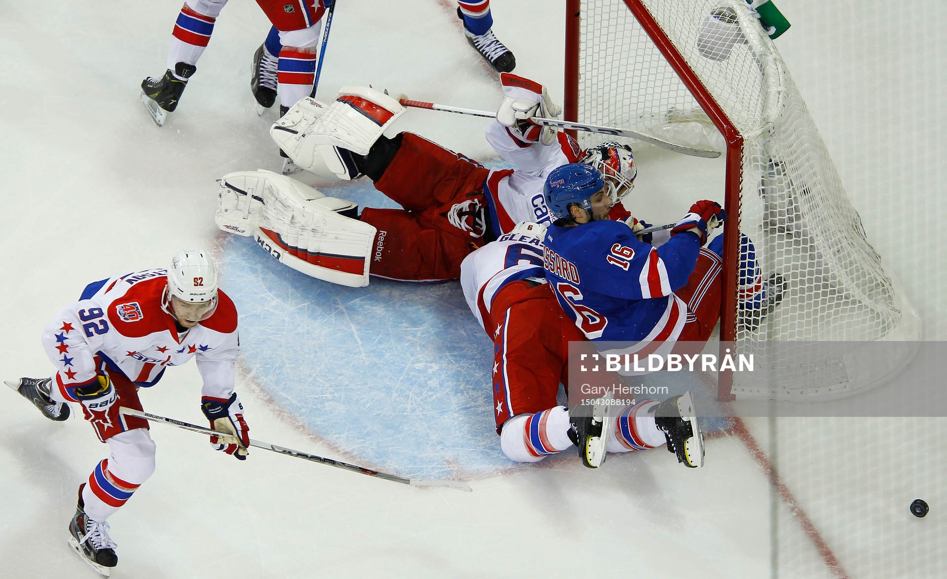 New York Rangers Derick Brassard (R) is knocked into the
